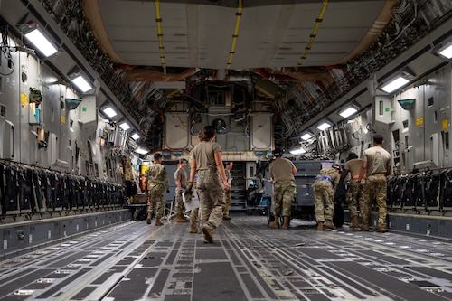 Airmen loading a C-17 Aircraft
