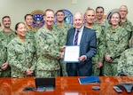 240801-N-PX998-2049 - Vice Adm. John Mustin, Chief of Navy Reserve and Commander, Navy Reserve Force, center left, and Gregg R. Pelowski, Director, Total Force Management, Military Sealift Command, center right, pose with a document that transfers oversight of the Strategic Sealift Officer (SSO) program to the Reserve Force on Aug. 1, 2024 at Commander, Navy Reserve Forces Command in Norfolk, Va. (U.S. Navy Photo by Mass Communication Specialist 2nd Class David C. Warren)