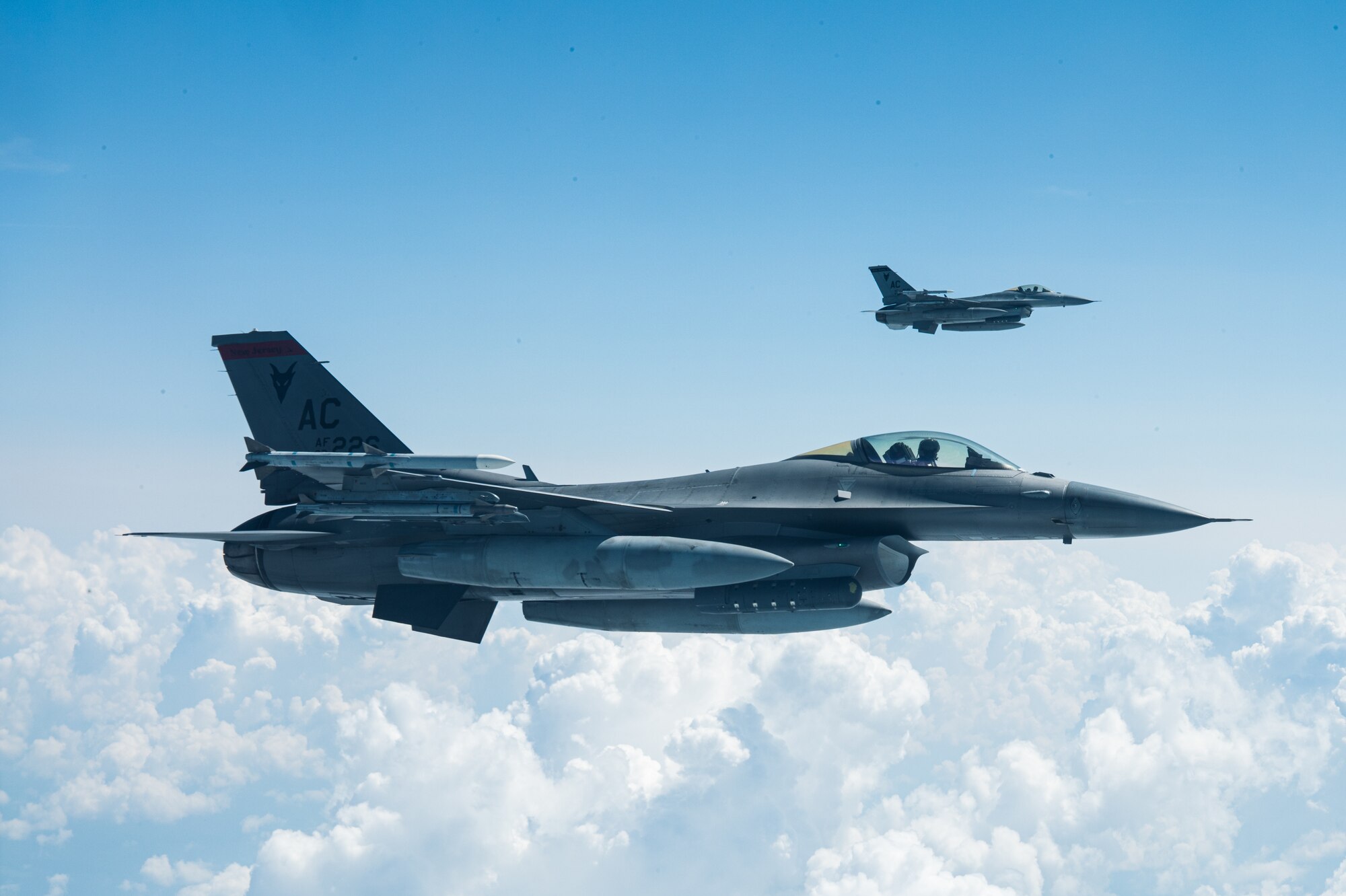 Two F-16C's assigned to the 177th Fighter Wing fly alongside a Niagara KC-135R Stratotanker assigned to the 914th Air Refueling Wing, awaiting refuel somewhere over the Northeastern United States.