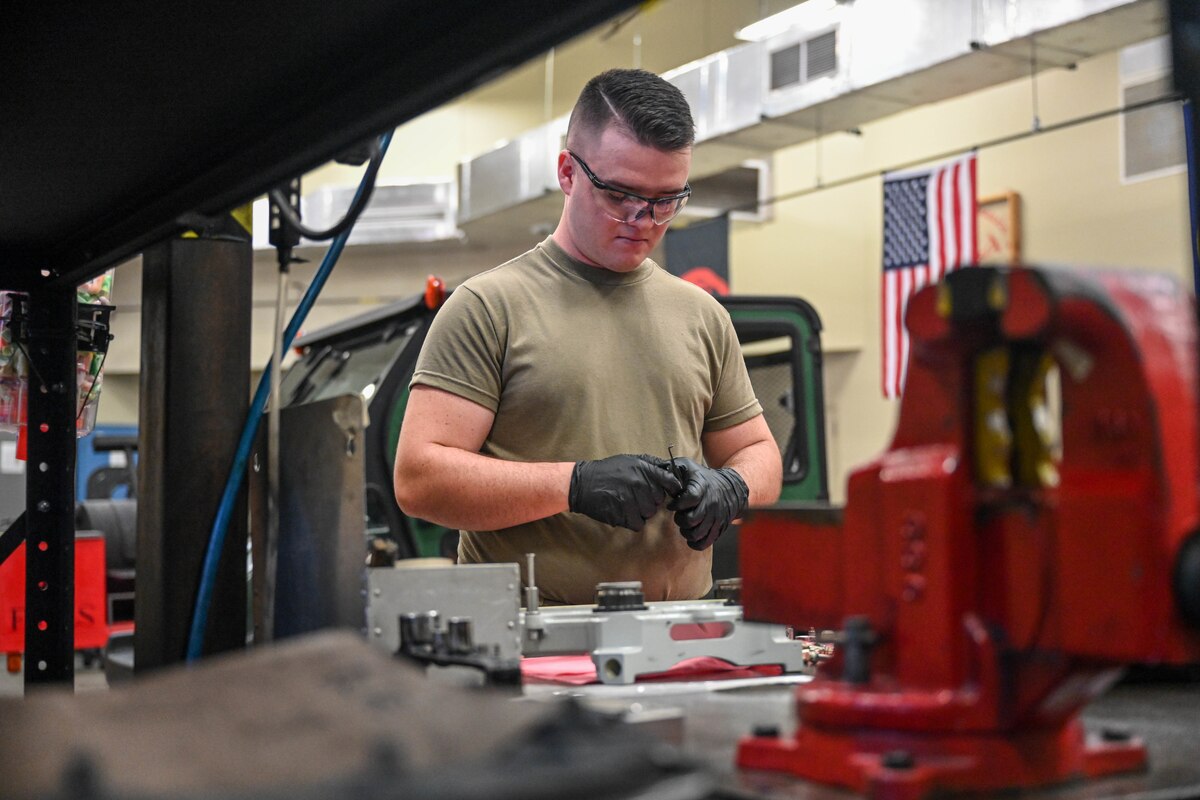 A man works in a mechanic shop.