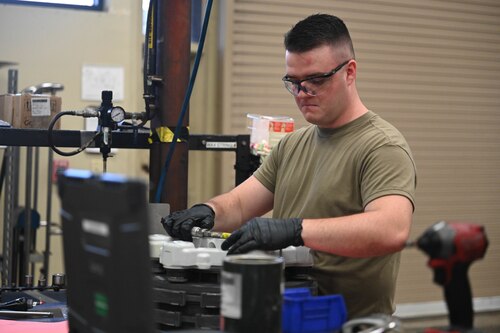 A man works in a mechanic shop.