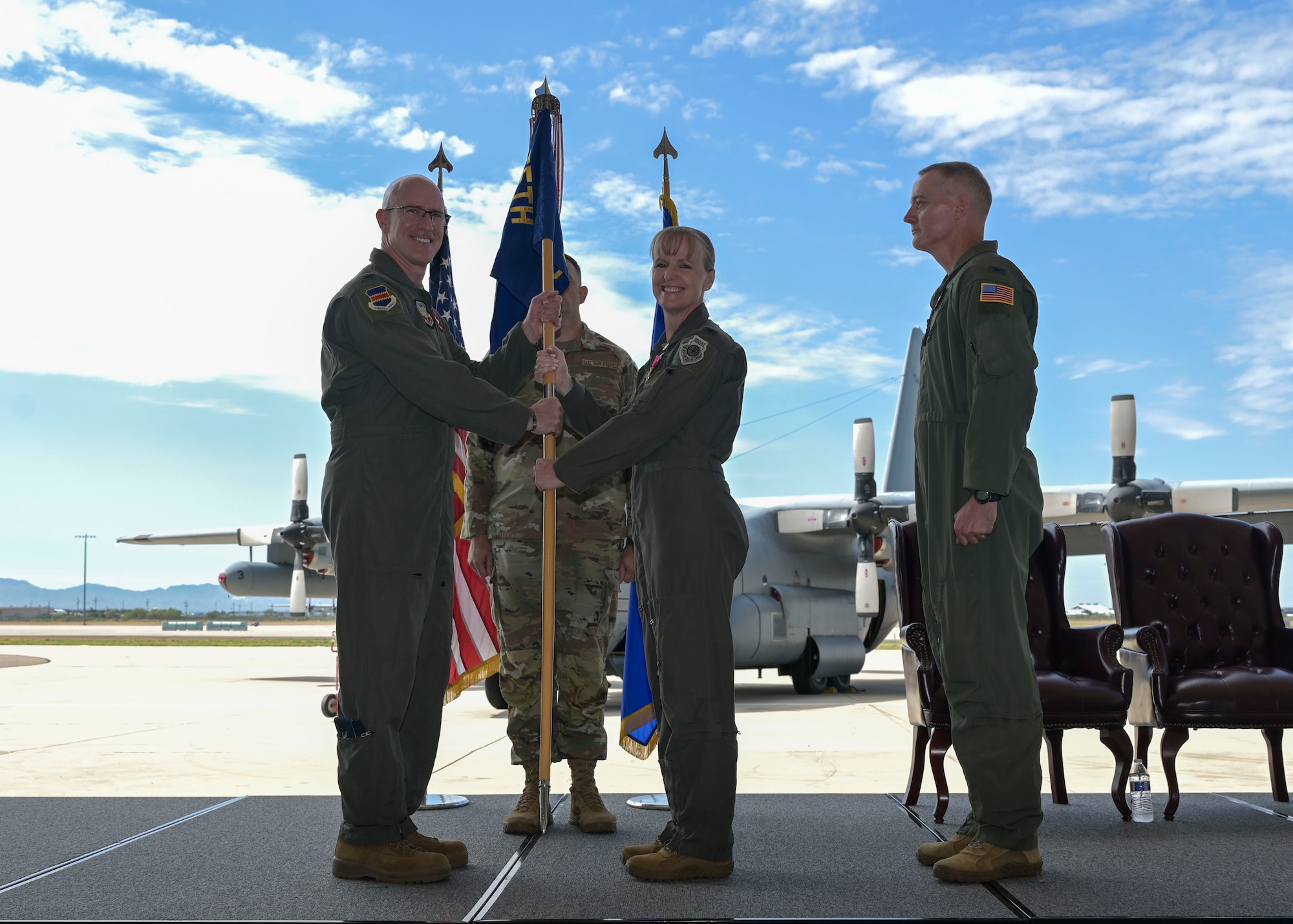 two commanders pose with guidon
