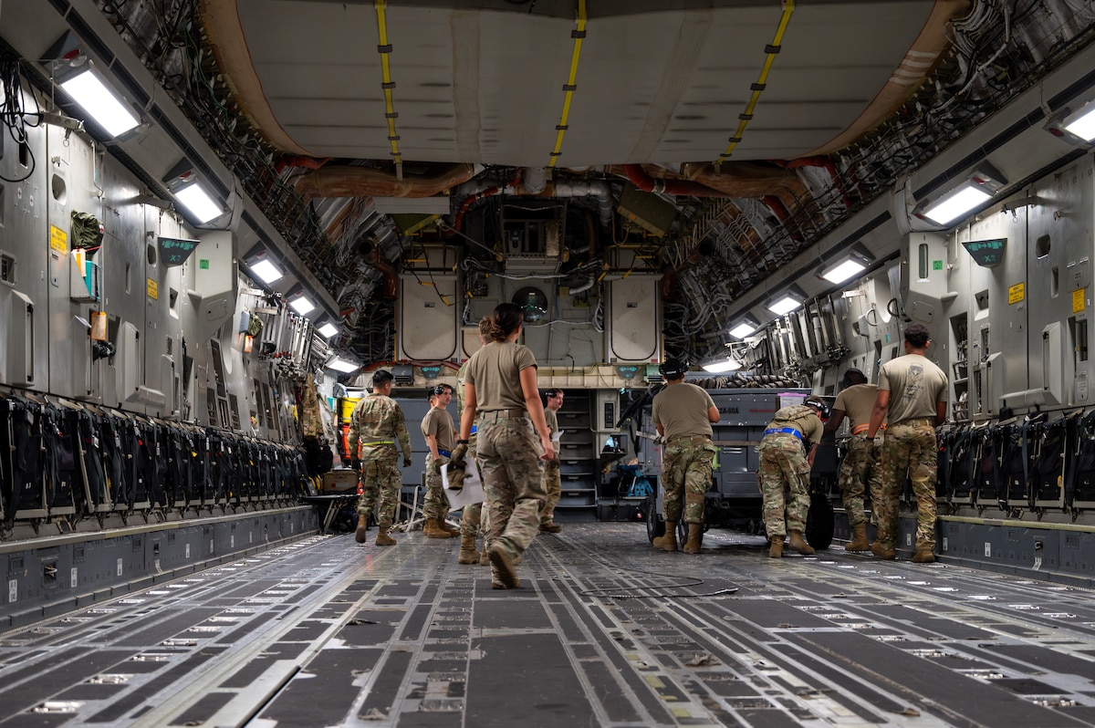 Airmen loading a C-17 Aircraft