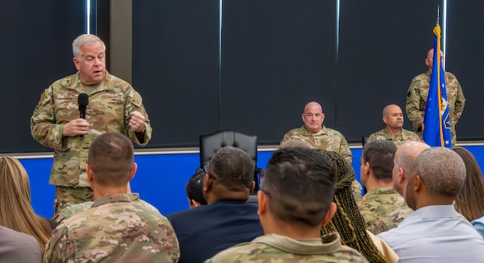 Maj. Gen. John Allen stand up to address the audience during ceremony