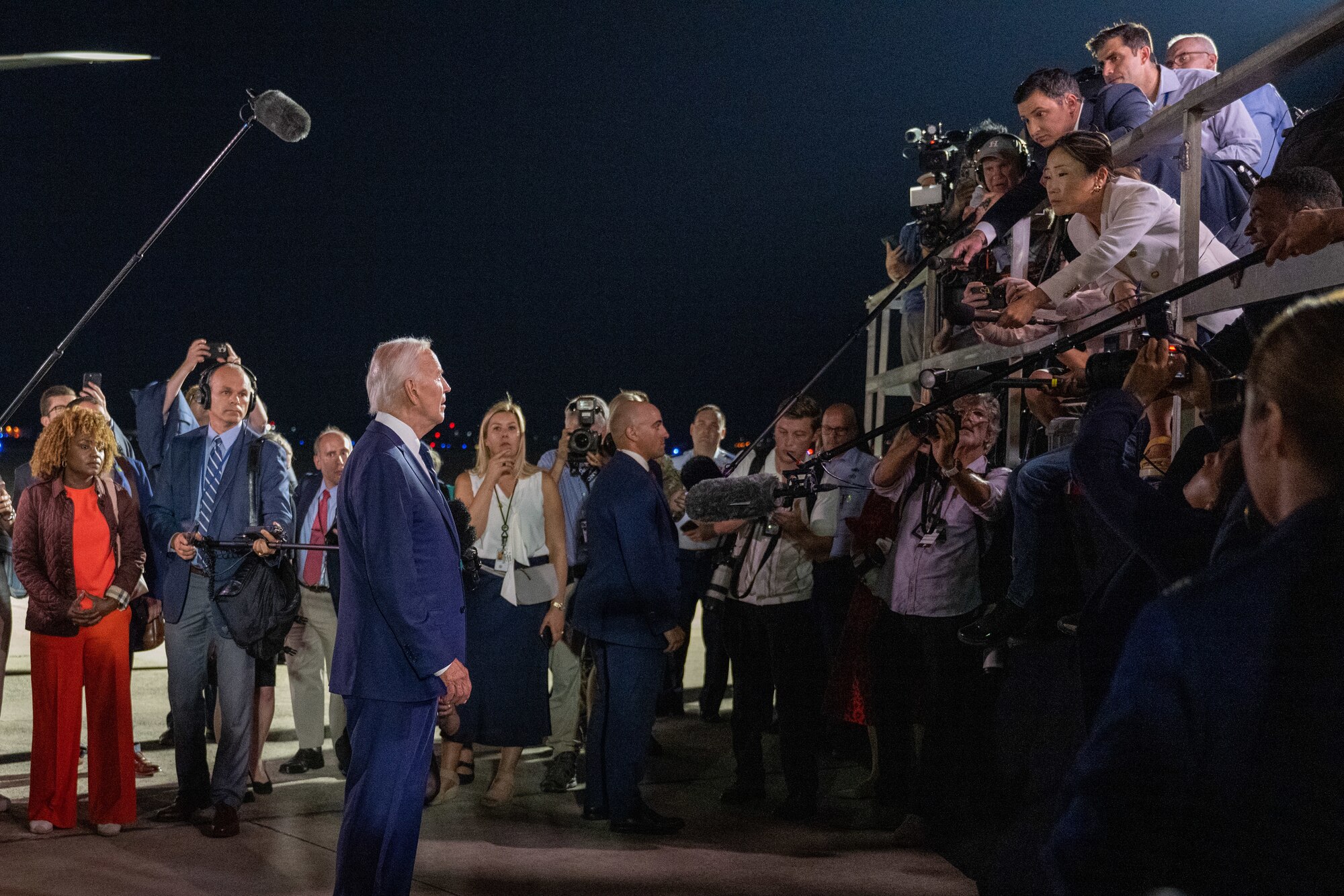 Man stands in front of reporters.