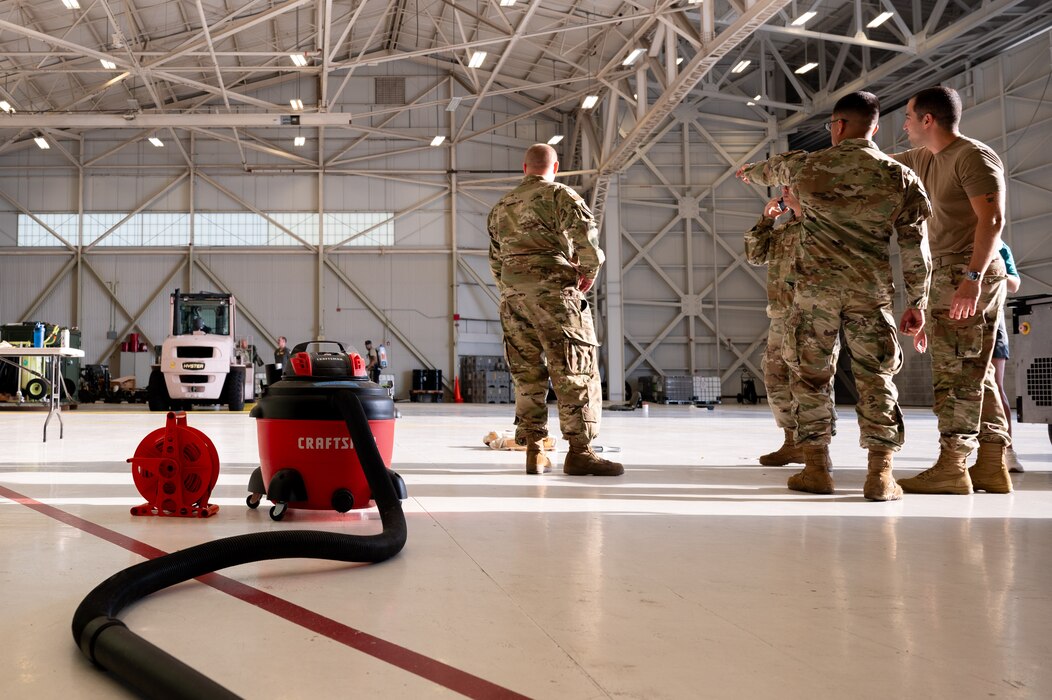U.S. service members and volunteers prepare and clean equipment for an upcoming agile combat exercise, Operation KENNY’S RETURN, at Joint Base Lewis-McChord, Washington, August 2, 2024. The 62d Airlift Wing will combine with various units to form the 7th Expeditionary Airlift Squadron for the exercise, including Airmen from the 7th Airlift Squadron and the 627th Air Base Group.