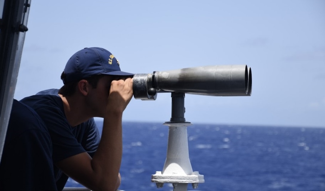 A Coast Guard Cutter Thetis (WMEC 910) crew member serves as a lookout, June 29, 2024, while underway at sea. Thetis’ crew conducted a 75-day maritime safety and security patrol in the Windward Passage and Florida Straits. (U.S. Coast Guard photo by Ensign Kevin Wong)