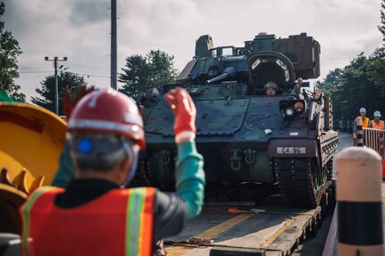 A U.S. Army Soldier assigned to 4th Battalion, 70th Armored Regiment, 1st Armored Brigade Combat Team, 1st Armored Division, loads a M2A3 IFV Bradley on a heavy equipment transport vehicle for transportation to a training area in support of a deployment readiness exercise at Camp Carroll, South Korea, July 28, 2024.