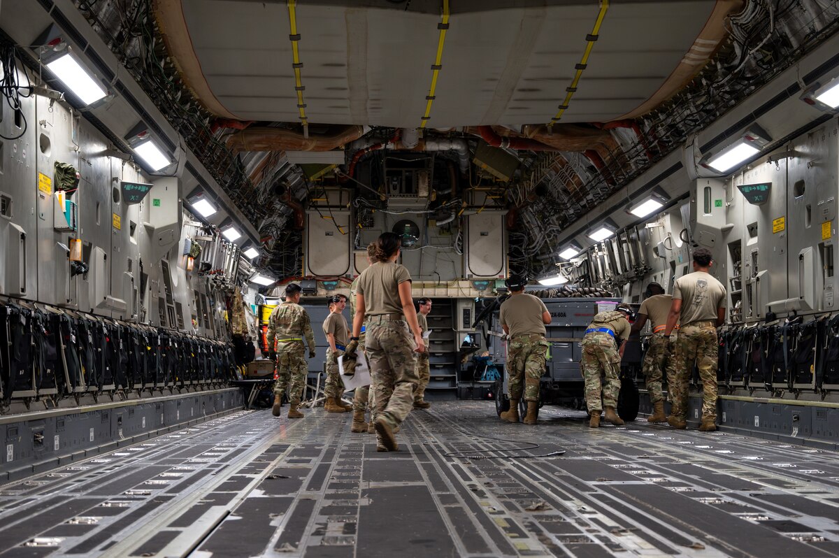 Airmen loading a C-17 Aircraft