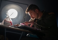 U.S. Air Force Capt. Jim Beidleman, 9th Airlift Squadron pilot, reviews maintenance forms before take off at Dover Air Force Base, Delaware, July 31, 2024. Beidleman was the aircraft commander for the flight to Westover Air Reserve Base. (U.S. Air Force photo by Airman Liberty Matthews)