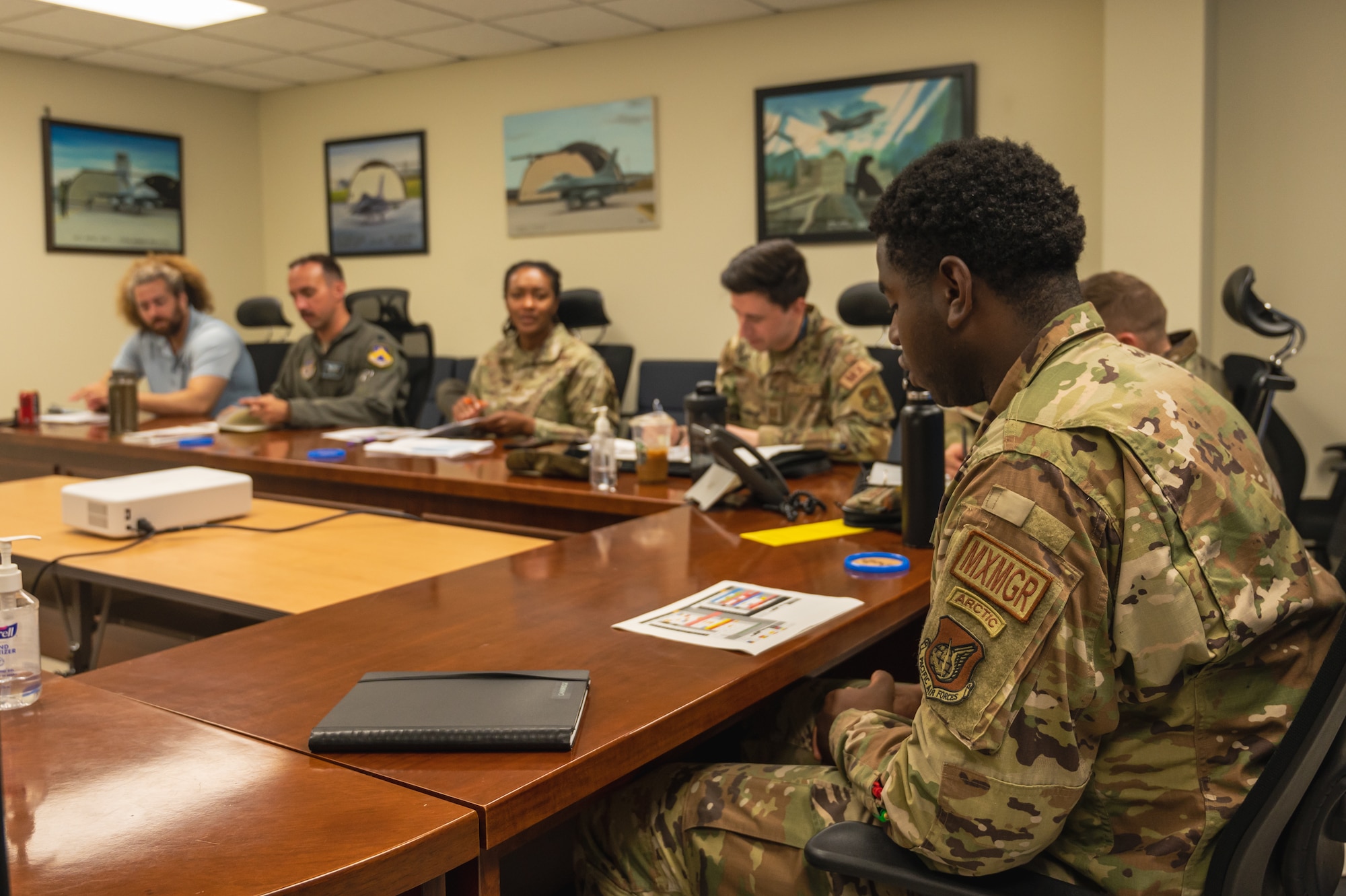 Senior Airman Deoviea Jackson, 8th Maintenance Group maintenance management scheduler, speaks at an operations meeting.