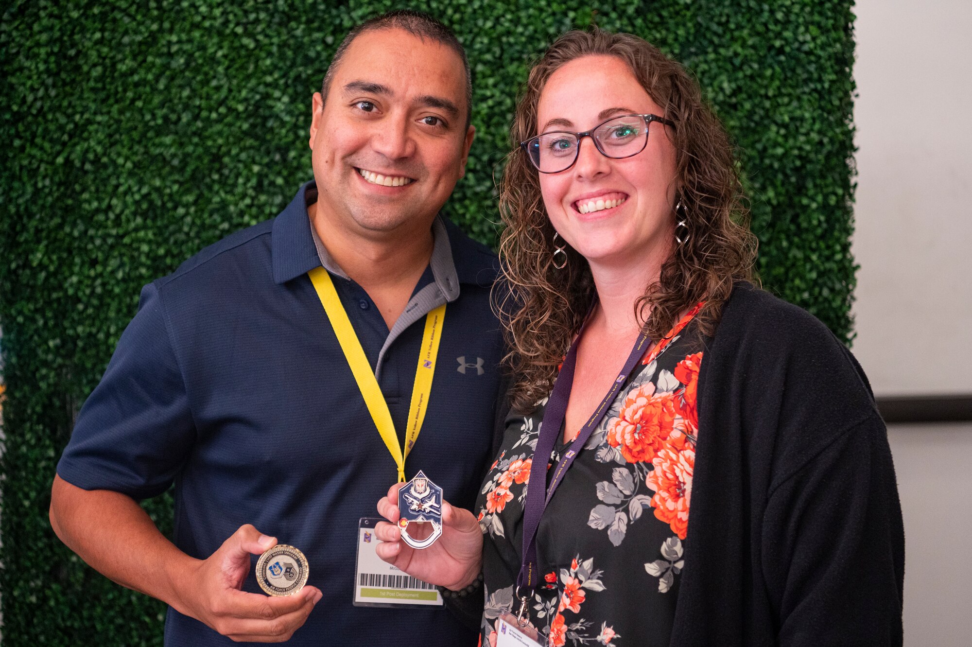 U.S. Air Force Tech. Sgt. Norman Beidler, an air transportation craftsman with the 88th Aerial Port Squadron, 514th Air Mobility Wing, and his wife, Rose Beidler, display challenge coins they received for demonstrating resilience during his recent deployment during a Yellow Ribbon event at the Sheraton San Diego Hotel and Marina, Calif., on July 21, 2024.
