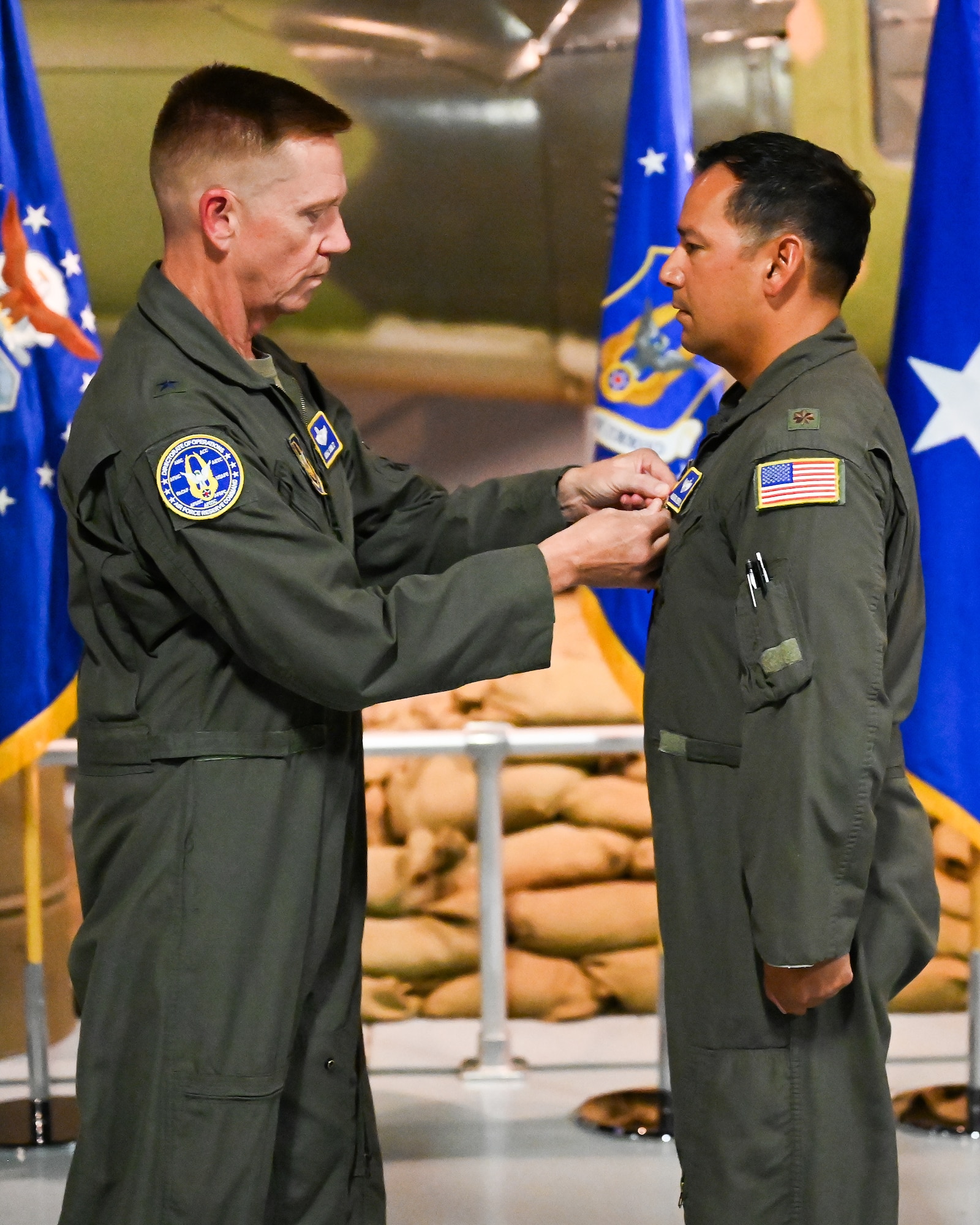 Photo of Brigadier General Michael Schultz pinning Airman's medal on Major Michael Medrano.