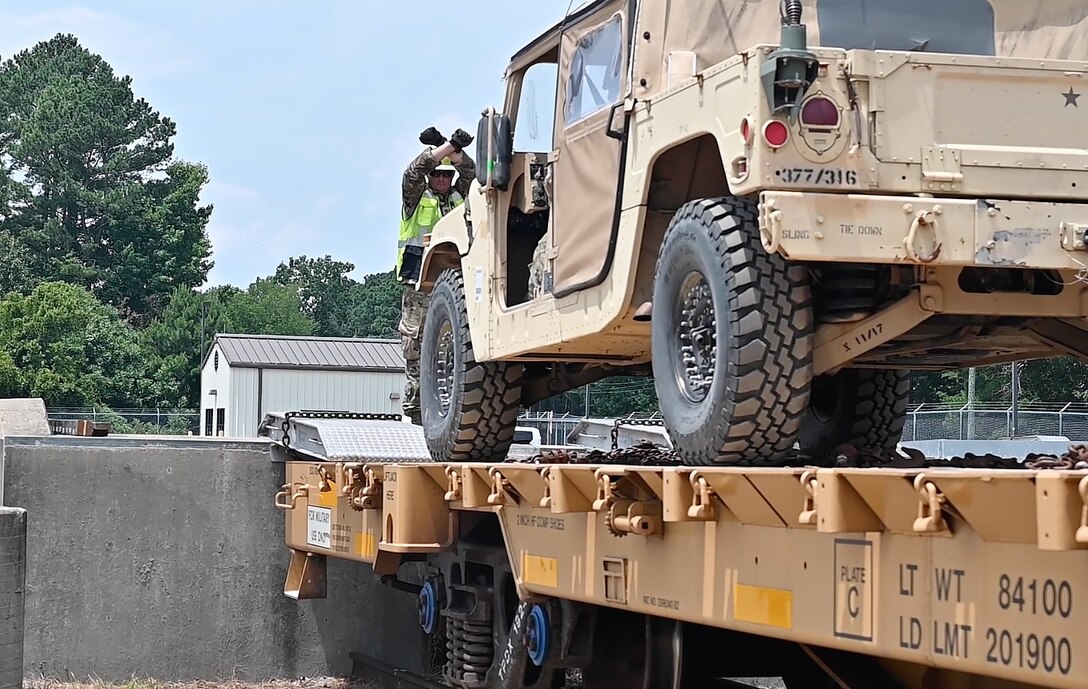 A Soldier directs a truck to stop