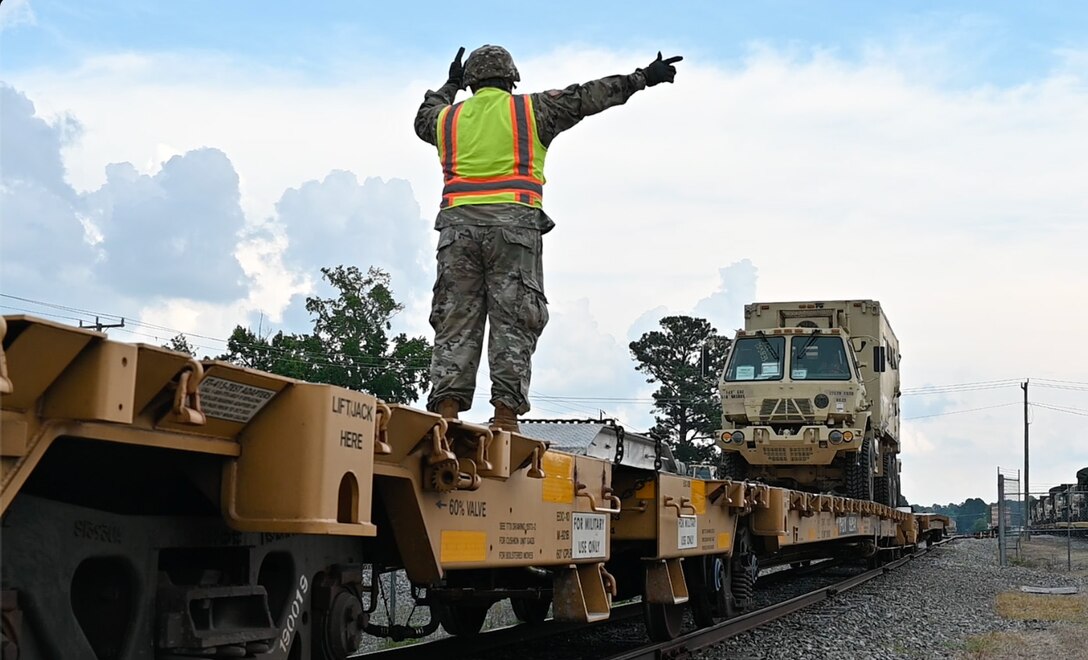 A Soldier directs a truck