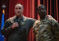 U.S. Air Force Col. Jesse Lamarand, 5th Bomb Wing (BW) commander (left), and Chief Master Sgt. Wayne Sharp, 5th BW command chief (right), host their inaugural 5th BW all-call at Minot Air Force Base, North Dakota, July 30, 2024. During the all-call, the team introduced themselves, their leadership philosophies, and their goals for their time at Minot AFB. (U.S. Air Force photo by Airman 1st Class Alyssa Bankston)