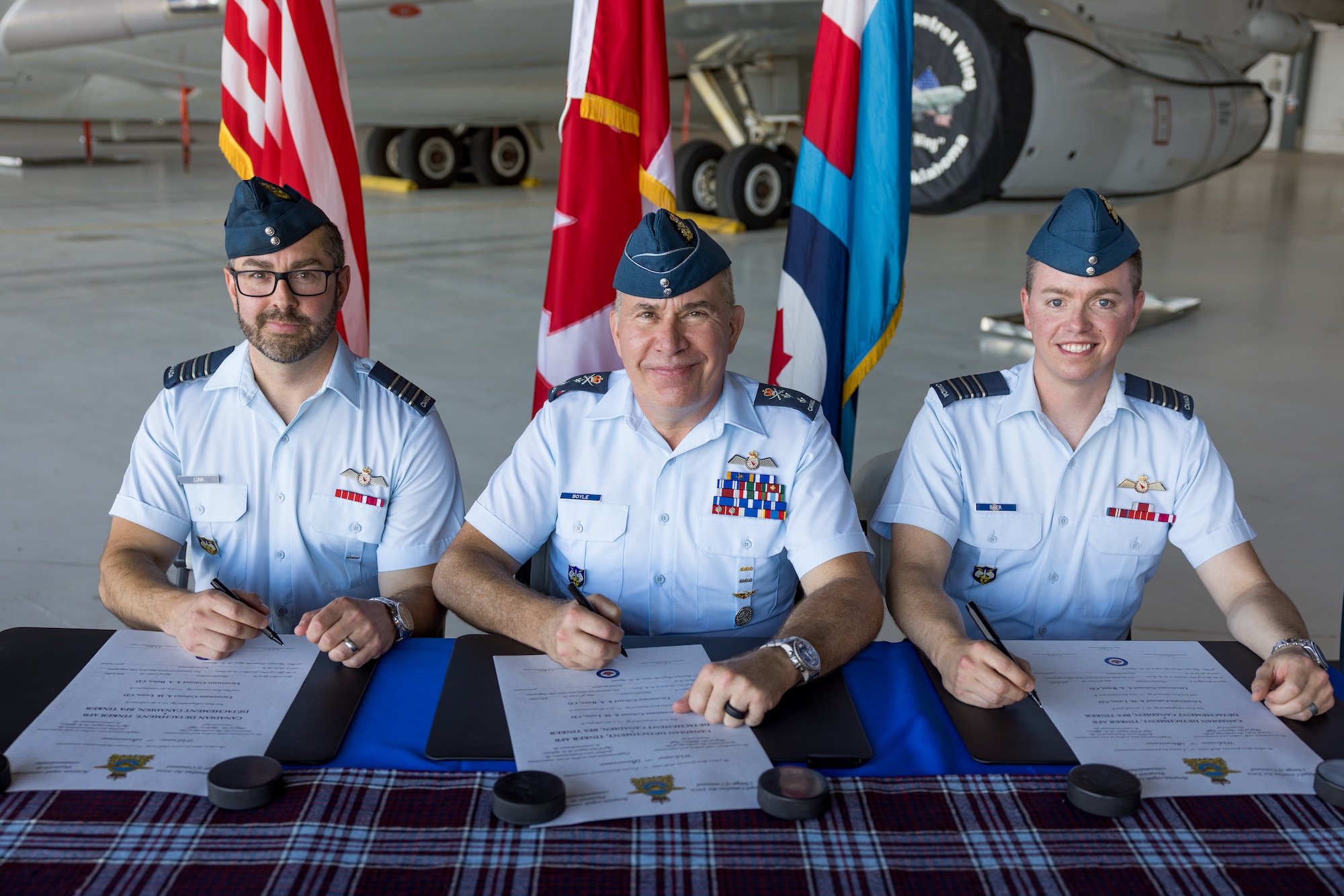 Three men sitting at table