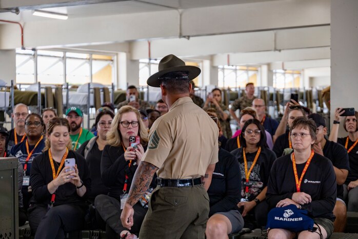 U.S. Marine Corps Staff Sgt. Lee Plourde, a senior drill instructor with Charlie Company, 1st Recruit Training Battalion, Recruit Training Regiment, gives a senior drill instructor speech as part of a mock pick-up event for the 2024 Educators' Workshop at Marine Corps Recruit Depot San Diego, Calif., July 16, 2024. Participants visited MCRD San Diego to observe recruit training and gain a better understanding about the transformation from recruits to United States Marines. Educators also received classes and briefs on the benefits that are provided to service members serving in the U.S. Armed Forces. (U.S. Marine Corps photo by Sgt. Lennon Dregoiw)