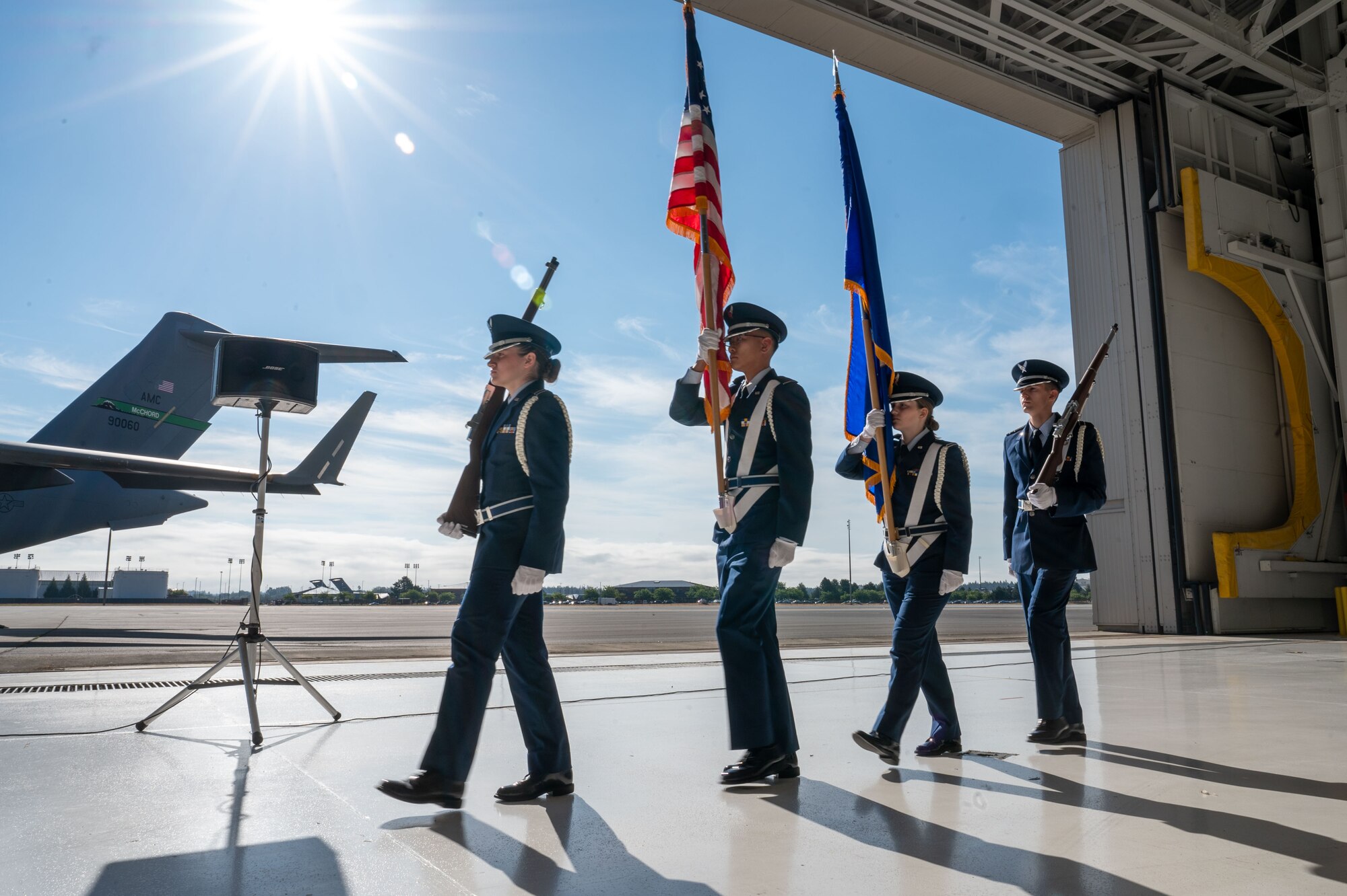 Honor Guard members march to present the colors prior to Col. Joseph Vanoni assuming command of 446th Airlift Wing in an assumption of command ceremony at Joint Base Lewis-McChord, Washington, on Aug. 3, 2024.