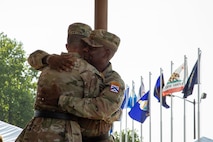 Commanding General of the Combined Arms Center and Fort Leavenworth Lt. Gen. Milford Beagle congratulates former Commanding General Cyber Center of Excellence Maj. Gen. Paul Stanton during a ceremony Aug. 2, 2024 at Barton Field on Fort Eisenhower, Ga.