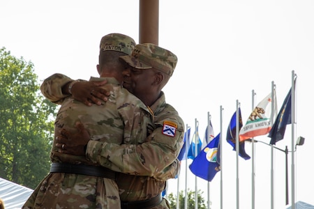 Commanding General of the Combined Arms Center and Fort Leavenworth Lt. Gen. Milford Beagle congratulates former Commanding General Cyber Center of Excellence Maj. Gen. Paul Stanton during a ceremony Aug. 2, 2024 at Barton Field on Fort Eisenhower, Ga.