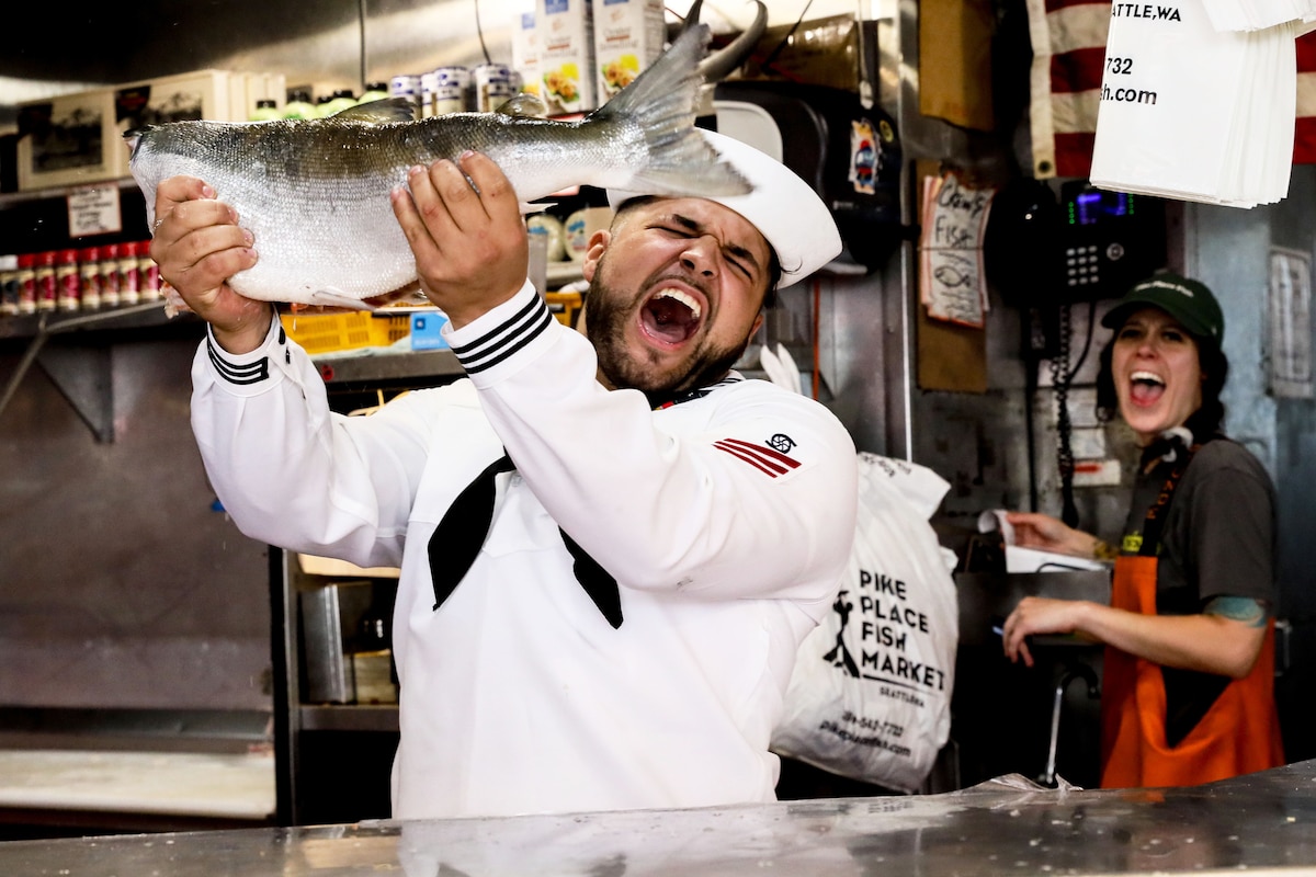 Navy Seaman Jaxon Moon catches a fish at Pike Place Market during Seattle Seafair Fleet Week, July 31, 2024. The week provides an opportunity for civilians in the region to meet Marines, sailors and Coast Guardsmen, and to witness firsthand the capabilities of the maritime services.