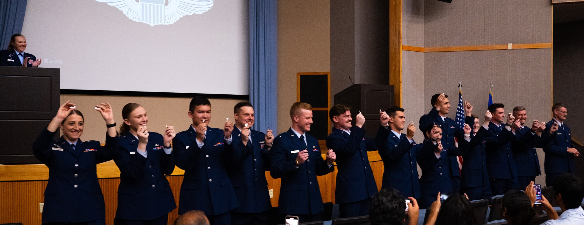 U.S. Air Force Airmen from graduating Class 24-13 break their wings at Laughlin Air Force Base, Texas, Aug. 2, 2024. Thirteen U.S. Air Force officers were awarded silver wings during the ceremony, symbolizing their completion of the Undergraduate Pilot Training program. (U.S. Air Force photo by Airman 1st Class Harrison Sullivan)