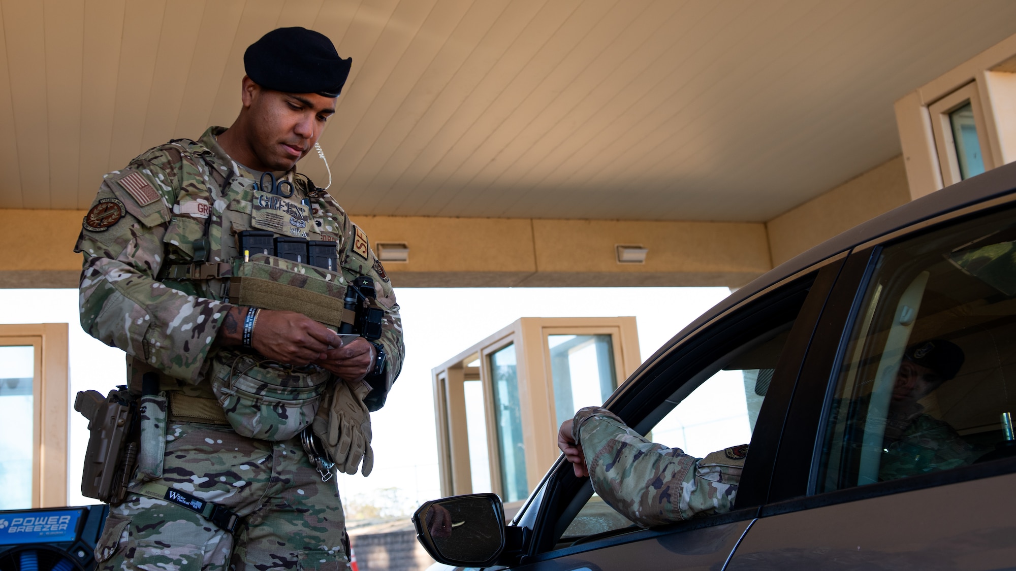 An Airman checking IDs at an entry control point