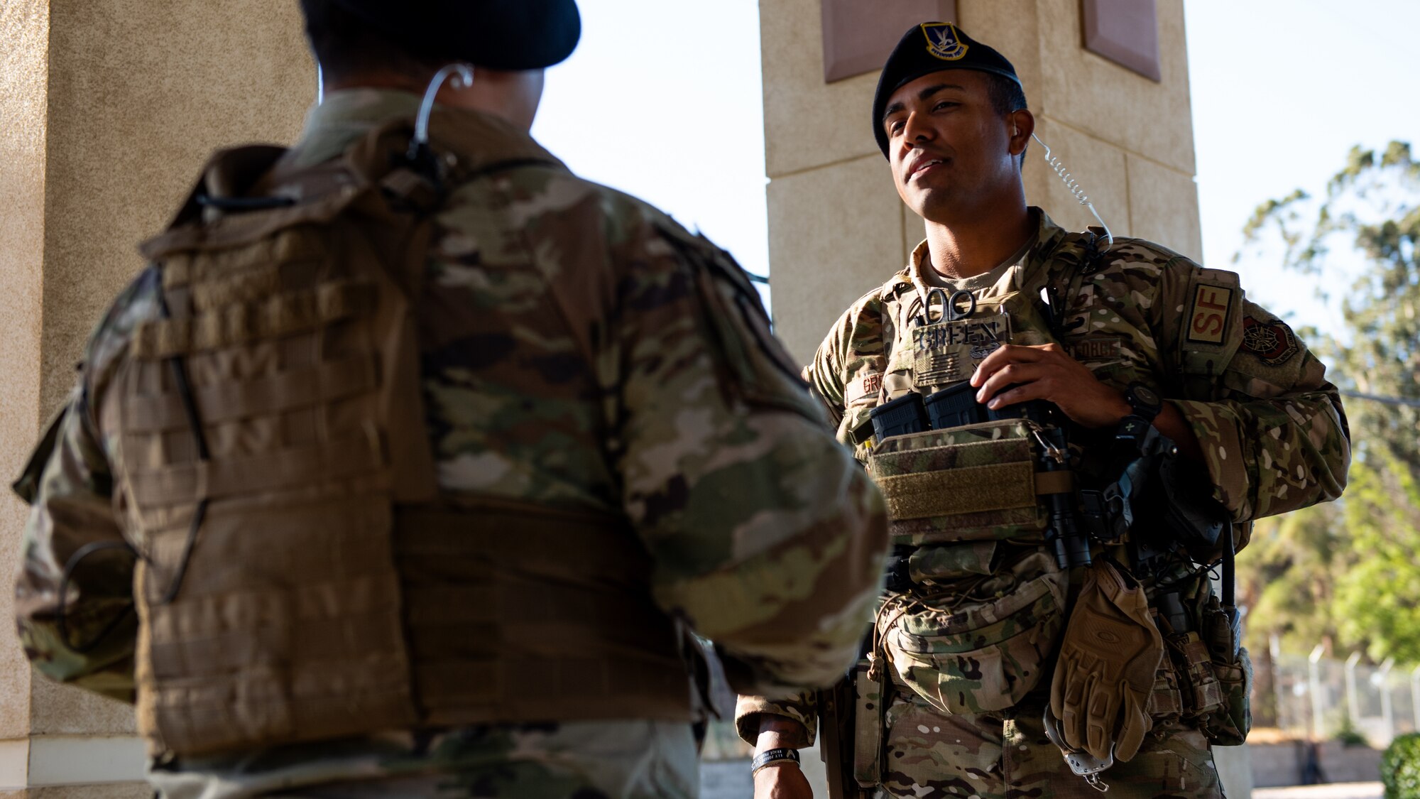 Airman speaks to another patrol at an entry control point