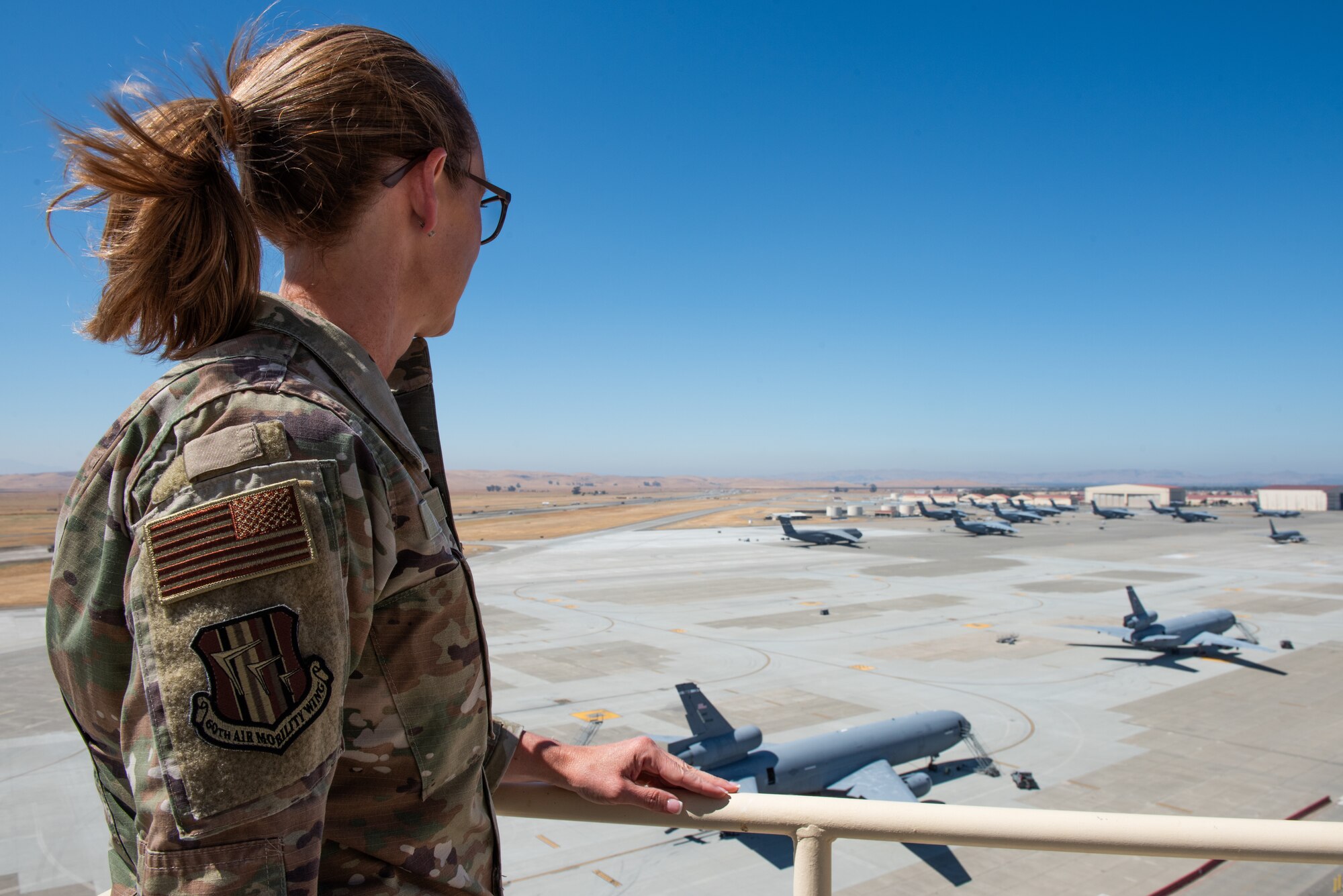 Command chief observing the flight line from the air traffic control tower catwalk.