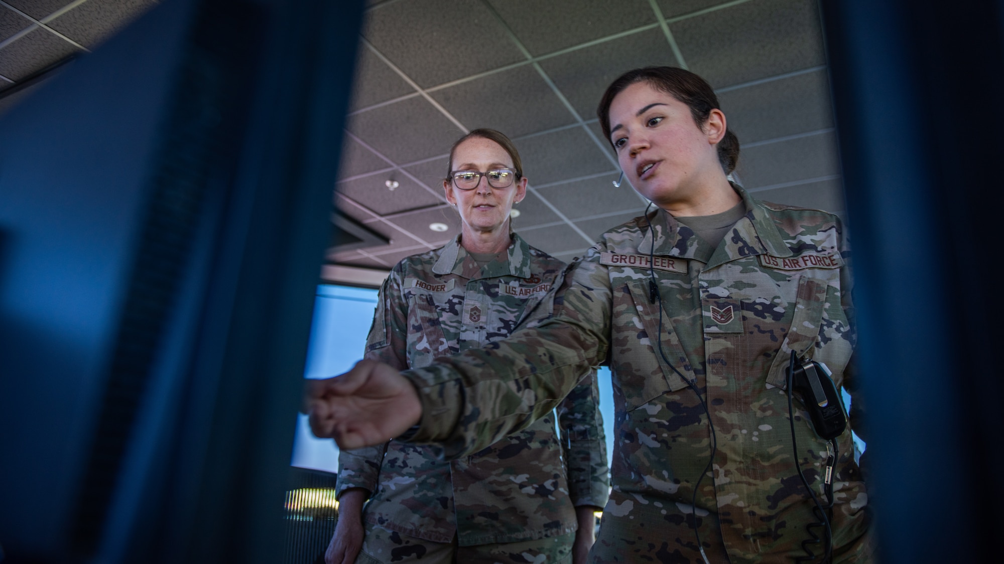 Command chief speaking with a watch supervisor in the air traffic control tower.