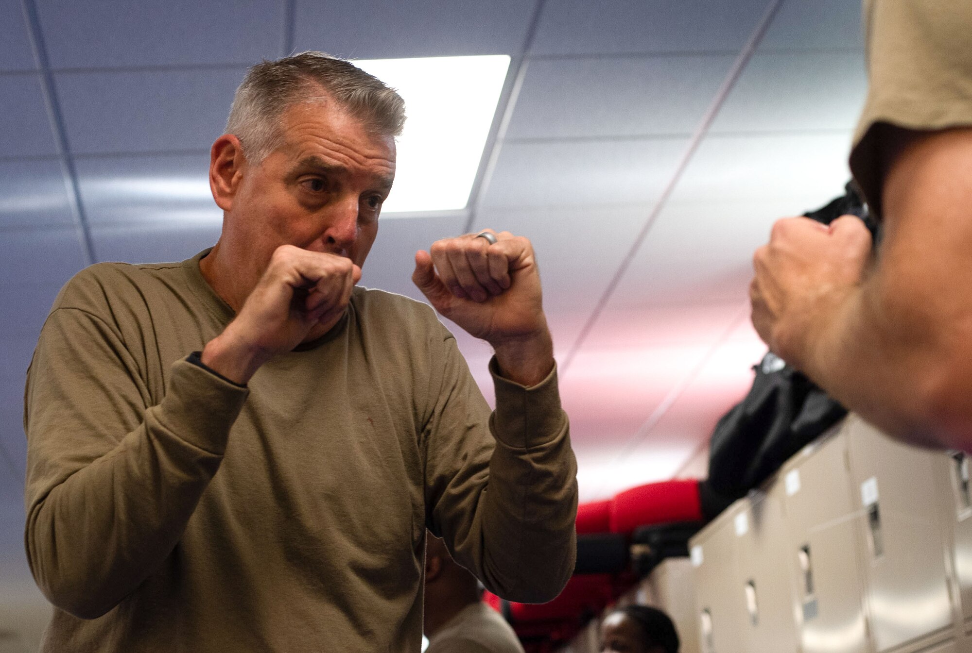 General Mike Minihan, commander of Air Mobility Command practices Krav Maga during the Command Chief Symposium at Scott Air Force Base, Illinois, July 31, 2024. This symposium, hosted by AMC and Chief Master Sgt. Jamie Newman, drove home the importance of maintaining a warfighter’s mindset. The symposium provided chiefs with the knowledge needed to improve or create their wing's own Warrior Heart program. (U.S. Air Force photo by Rachel Sansano)