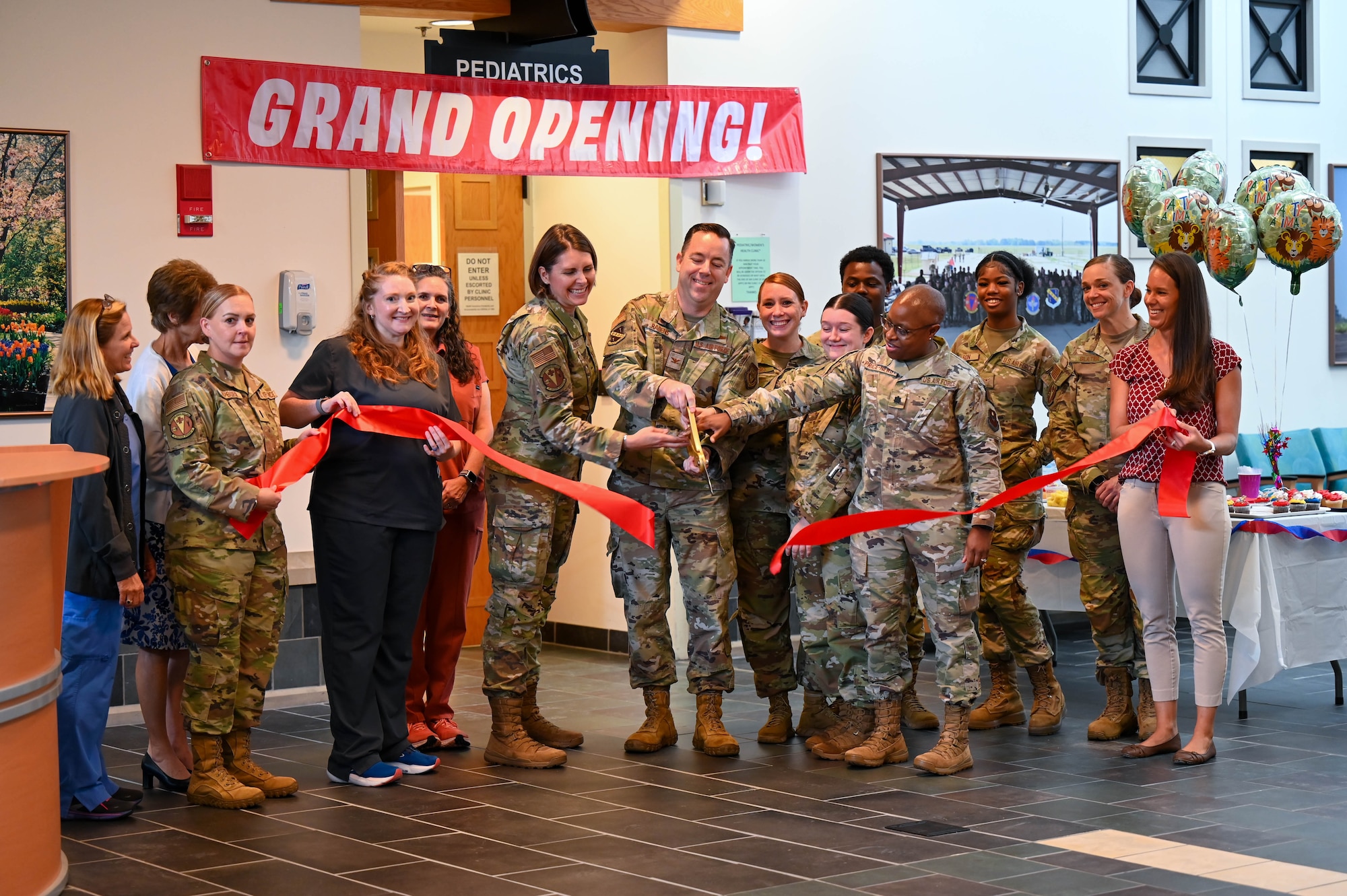 Members of the 42d medical group, cut the ribbon commemorate the grand re-opening of Maxwell’s Pediatric Clinic Aug. 1, 2024. The clinic, located on the first floor of the medical treatment facility right inside the front door, will offer full primary care pediatrics for children from birth to age 18. (U.S. Air Force Photo by Airman 1st Class Tyrique Barquet)