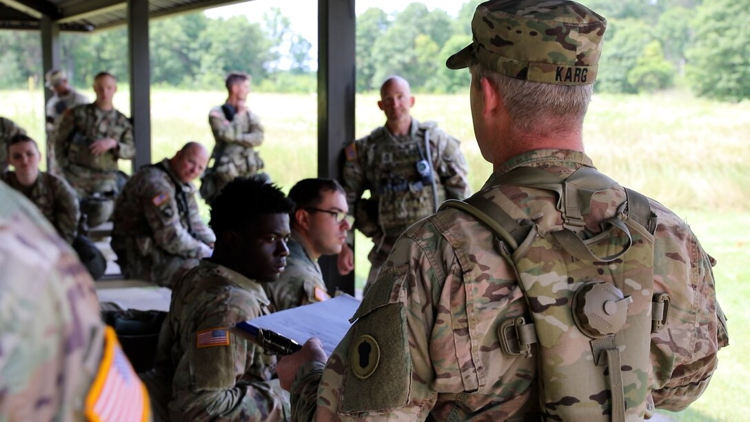 Army Maj. Herb Karg 87th Training Division, 1st Brigade, 1st Mission Control Training Detachment, provides feedback to Soldiers from the 402nd Quartermaster Battalion after a WAREX scenario, July 24,2024, Fort McCoy, Wis. (Photo by Sgt 1st Class Justin Hardin)