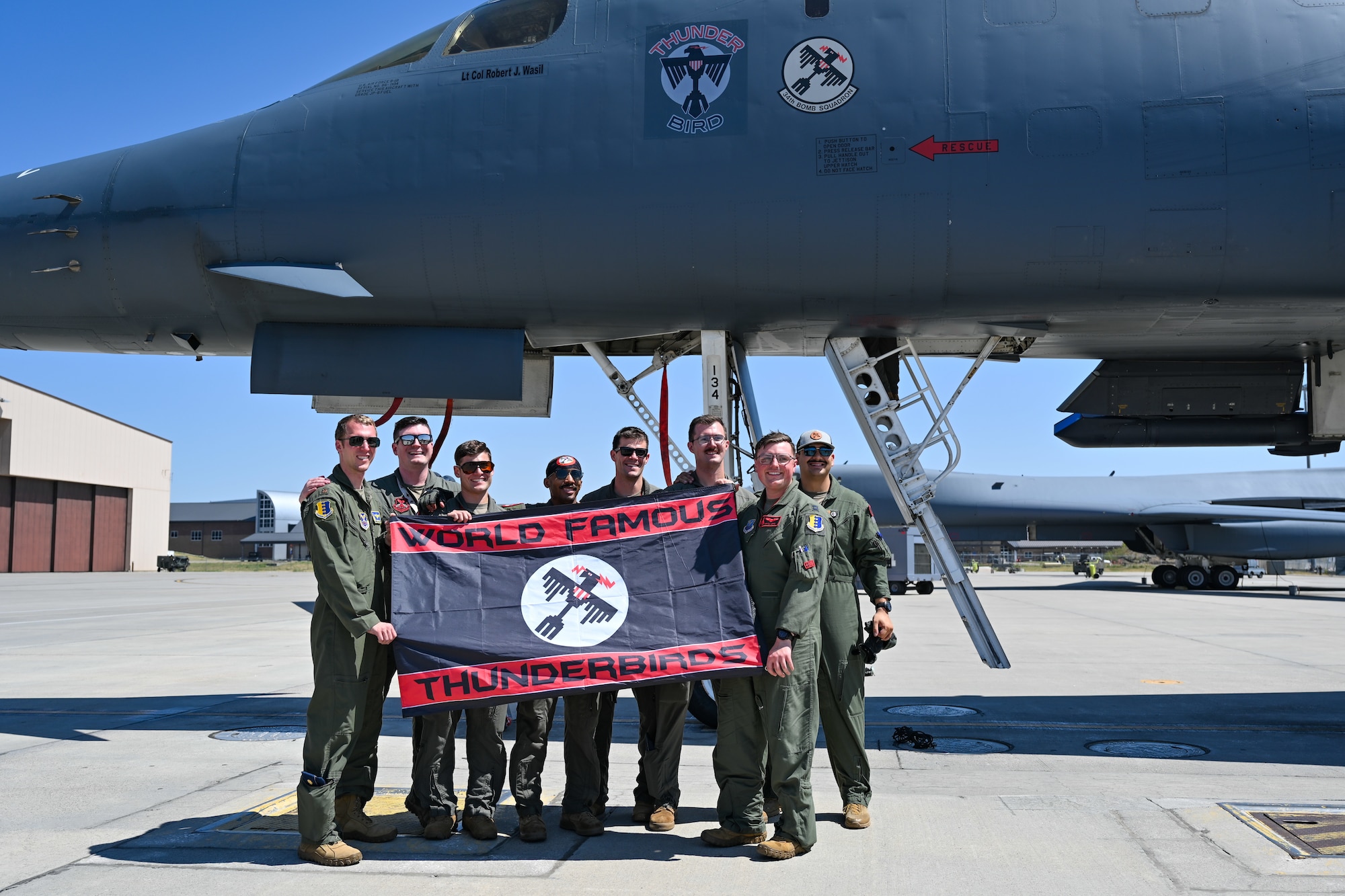 Aircrew from the 34th Bomb Squadron gather for a group photo after returning from a CONUS-to-CONUS bomber mission at Ellsworth Air Force Base, S.D., Aug. 2, 2024. U.S. Strategic Command supports the global effects coordination process, meaning we are prepared to facilitate both conventional and strategic strikes with other combatant commands in multiple geographic areas and domains. (U.S. Air Force photo by Staff Sgt. Jake Jacobsen)