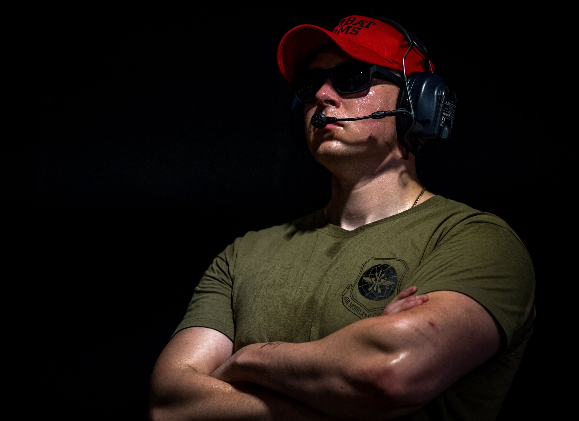 A combat arms Airman watches Command Chiefs from Air Mobility Command shoot live ammunition at Scott Air Force Base, Illinois, July 31, 2024. AMC and Chief Master Sgt. Jamie Newman, AMC command chief, hosted a Command Chief Symposium, driving home the importance of maintaining a warfighter’s mindset. The symposium provided chiefs with the knowledge needed to improve or create their wing's own Warrior Heart program. (U.S. Air Force photo by Rachel Sansano)