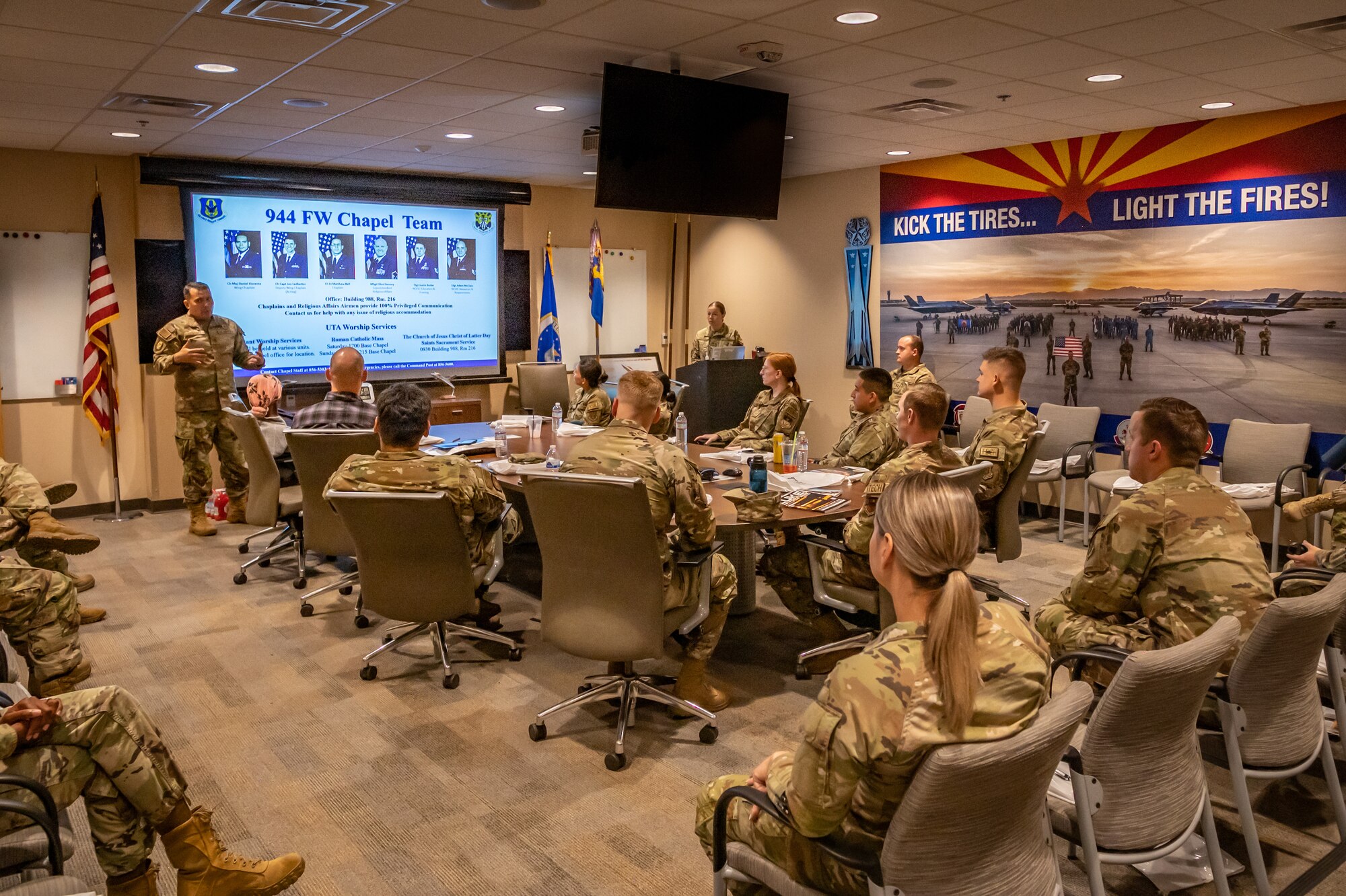 Reserve Citizen Airman Maj. Daniel Llorente, 944th Fighter Wing Chaplain, briefs 23 new members of the 944th FW during their newcomers’ orientation at Luke Air Force Base, Aug. 3, 2024. This was the first newcomers orientation hosted at the joint 56th and 944th Aircraft Maintenance Squadron building, selected for its strategic and welcoming setup. “This location allows newcomers to see our mission firsthand,” said Llorente. “F-35 pilot training and maintenance are right on our doorstep, making it not just an orientation but an immediate immersion into our core activities.” (U.S. Air Force photo by Tech. Sgt. Tyler J. Bolken)