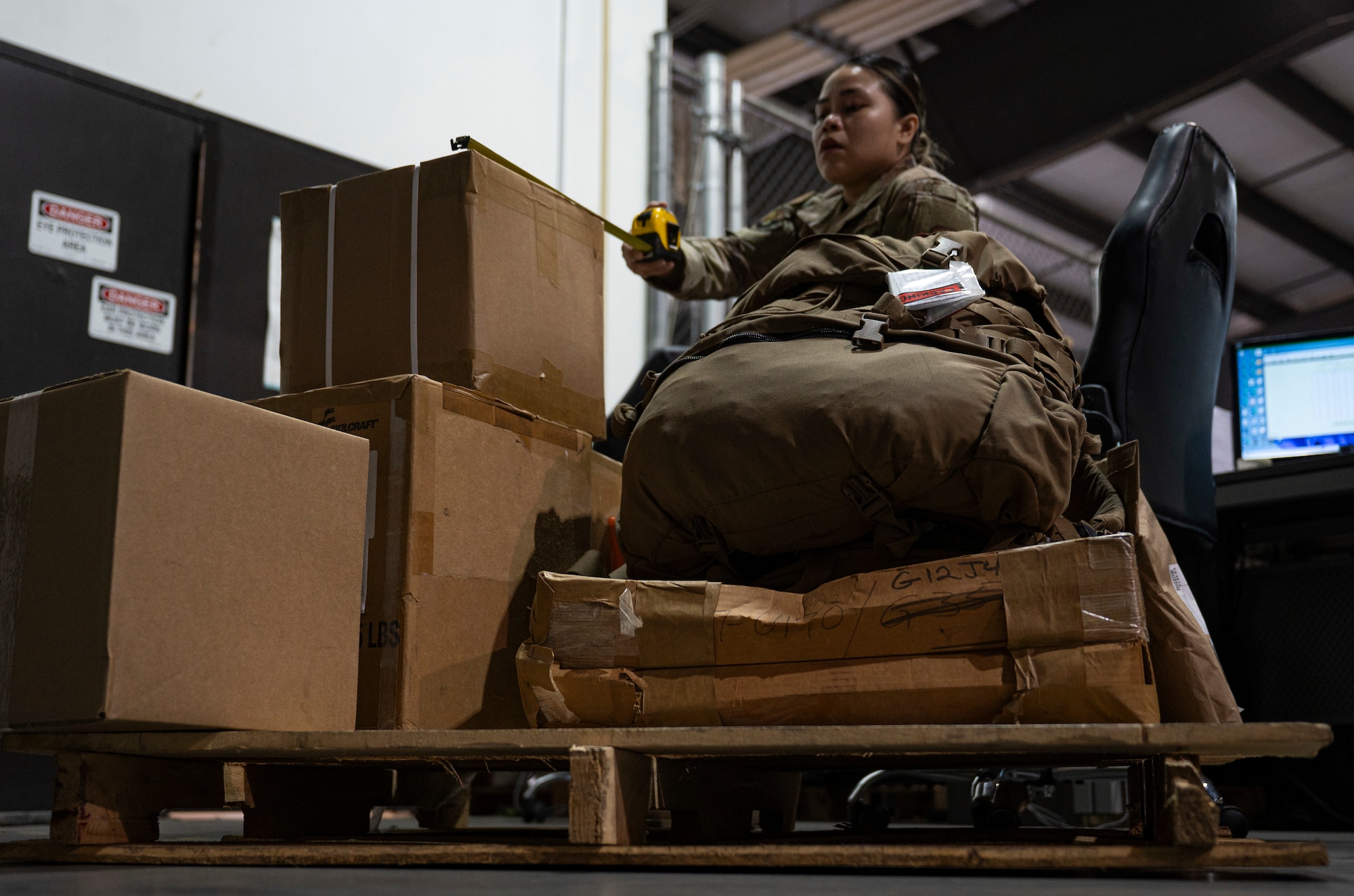 U.S. Air Force Airman 1st Class Roshelle Jandonero, 436th Aerial Port Squadron packing and crating lead, measures a package at Dover Air Force Base, Delaware, July 26, 2024. Jandonero leads packing and crating for outbound cargo for the 436th APS, the largest aerial port in the Department of Defense. (U.S. Air Force photo by Airman Liberty Matthews)