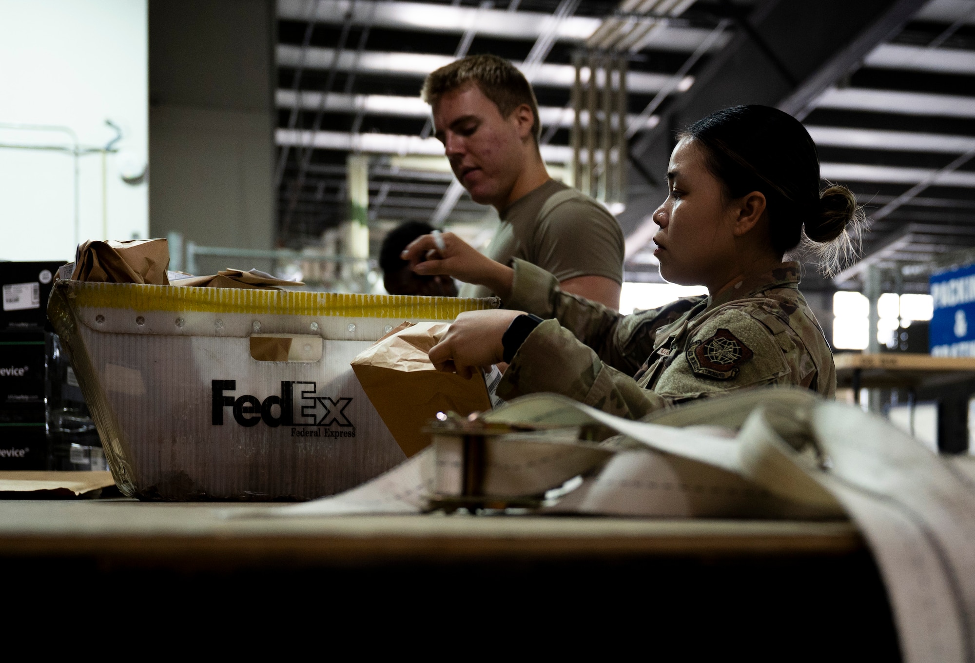 U.S. Air Force Airman 1st Class Roshelle Jandonero, right, 436th Aerial Port Squadron packing and crating lead, and Airman 1st Class Alex Stahleker, 436th APS packing and crating specialist, organize a shipment at Dover Air Force Base, Delaware, July 26, 2024. Jandonero leads packing and crating for outbound cargo for the 436th APS, the largest aerial port in the Department of Defense. (U.S. Air Force photo by Airman Liberty Matthews)