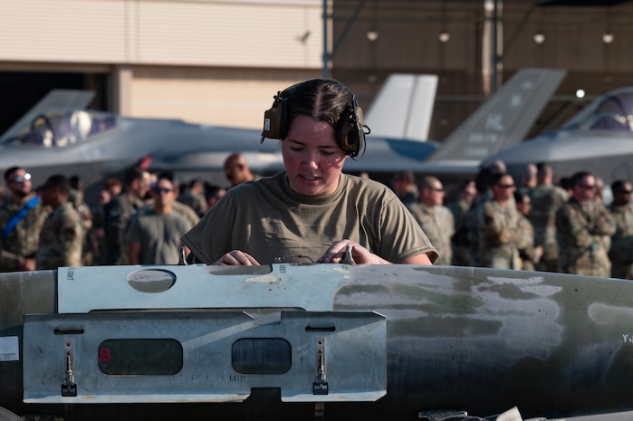 U.S. Air Force Senior Airman Eva Castillo, a 757th Aircraft Maintenance Squadron, Thunder Aircraft Maintenance Unit, weapons load crew member, prepares to load a Joint Direct Attack Munition GBU-32 during a weapons load crew competition at Nellis AFB, Nevada, July 26, 2024.