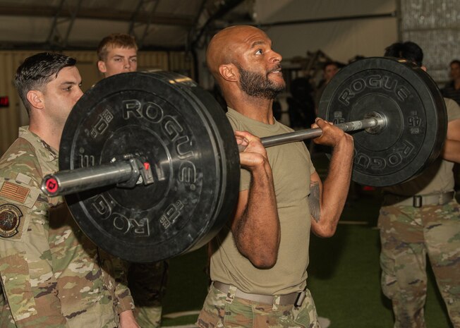 U.S. Air Force Staff Sgt. Shelton Thigpen, weapons load crew member assigned to the 94th Fighter Generation Squadron at Joint Base Langley-Eustis, Virginia, does a push press during a physical fitness assessment at Nellis Air Force Base, Nevada, July 24, 2024.