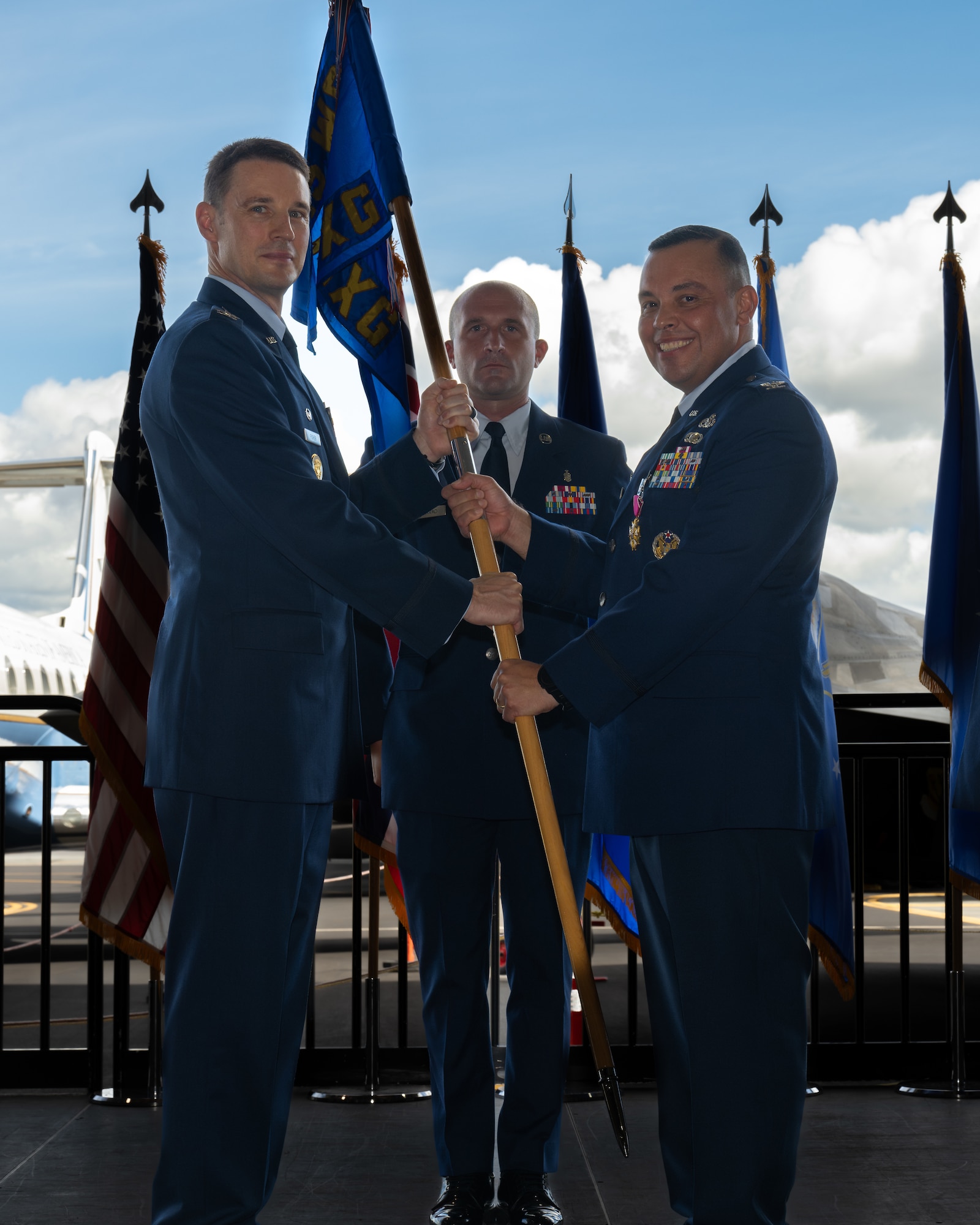 Airmen hold guidon during a ceremony.