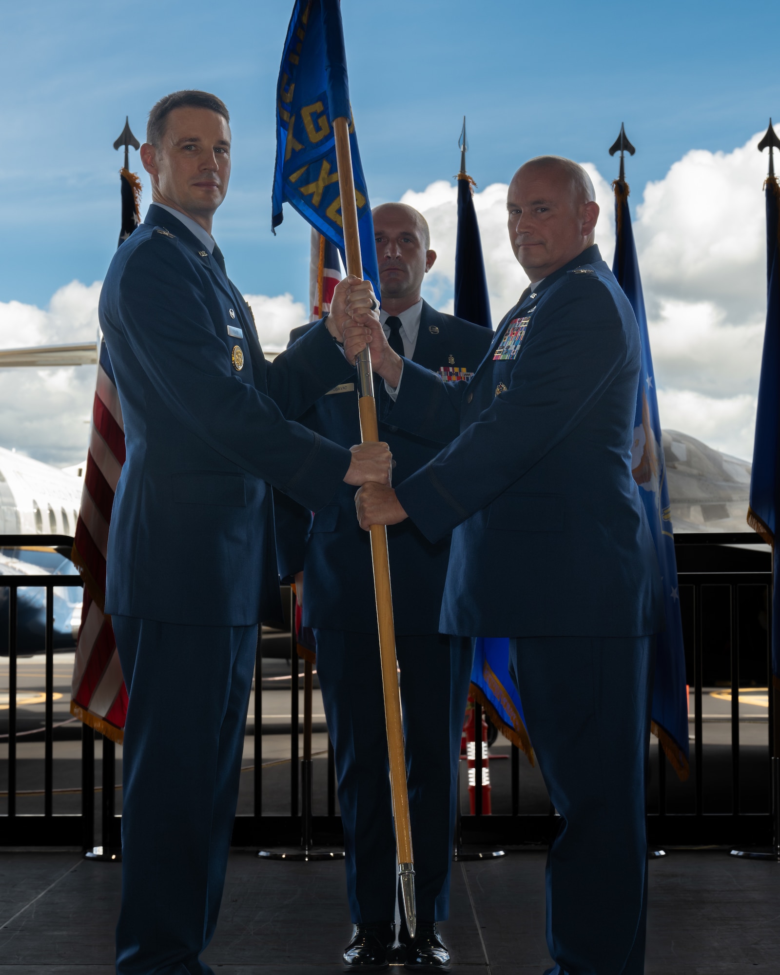 Airmen hold guidon during a ceremony.
