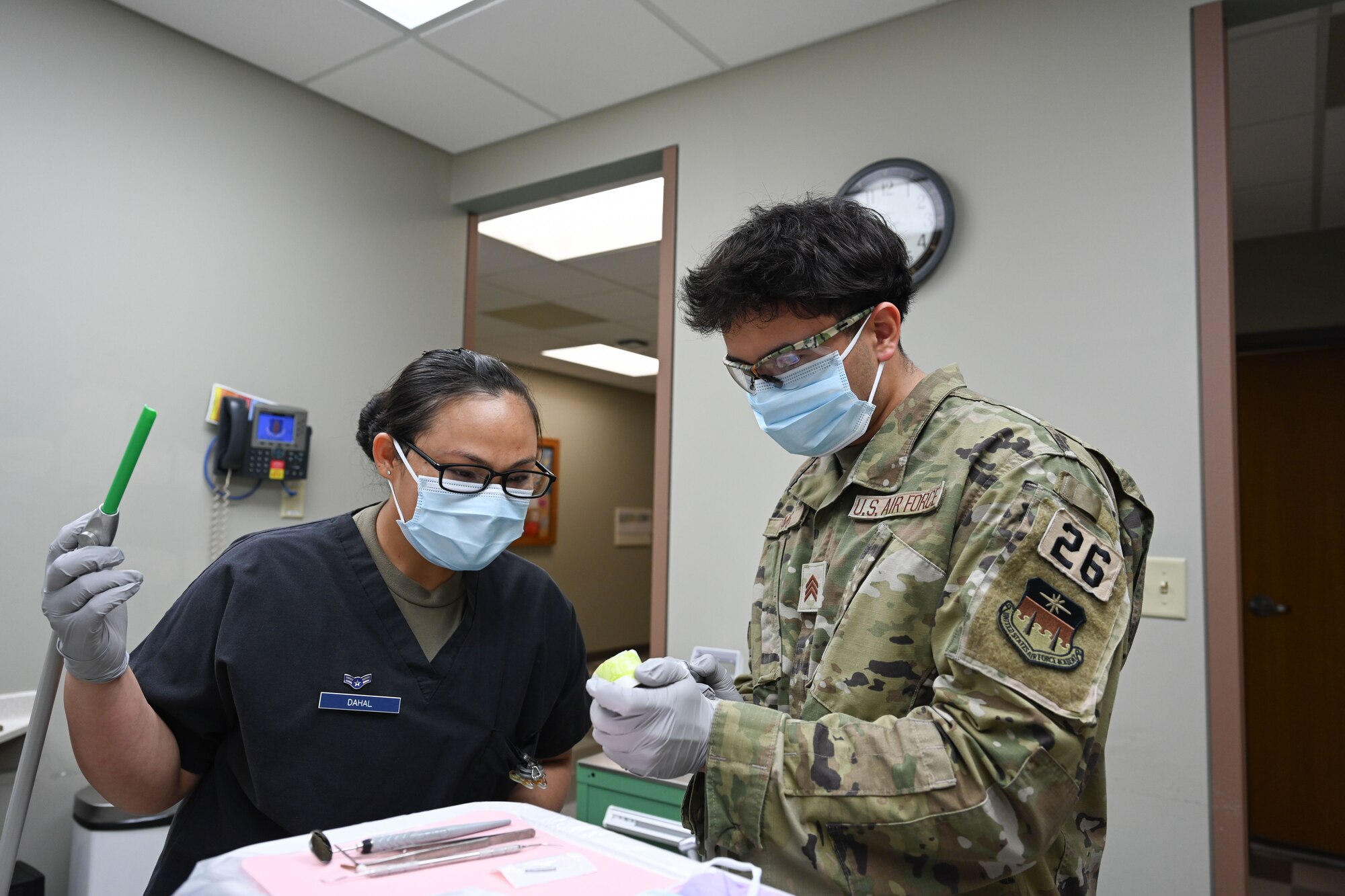 U.S. Airman 1st Class Khagindra Dahal, 97th Operational Medical Squadron dental assistant, left, demonstrates tooth decay removal to Jesus Lamas, U.S. Air Force Academy Cadet, during a tour of the 97th Medical Group at Altus Air Force Base, Oklahoma, June 6, 2024. Cadets were able to interact with Airmen in civilian, company grade officer, and enlisted positions to get a better understanding of how the Air Force works before they commission. (U.S. Air Force photo by Airman 1st Class Jonah Bliss)