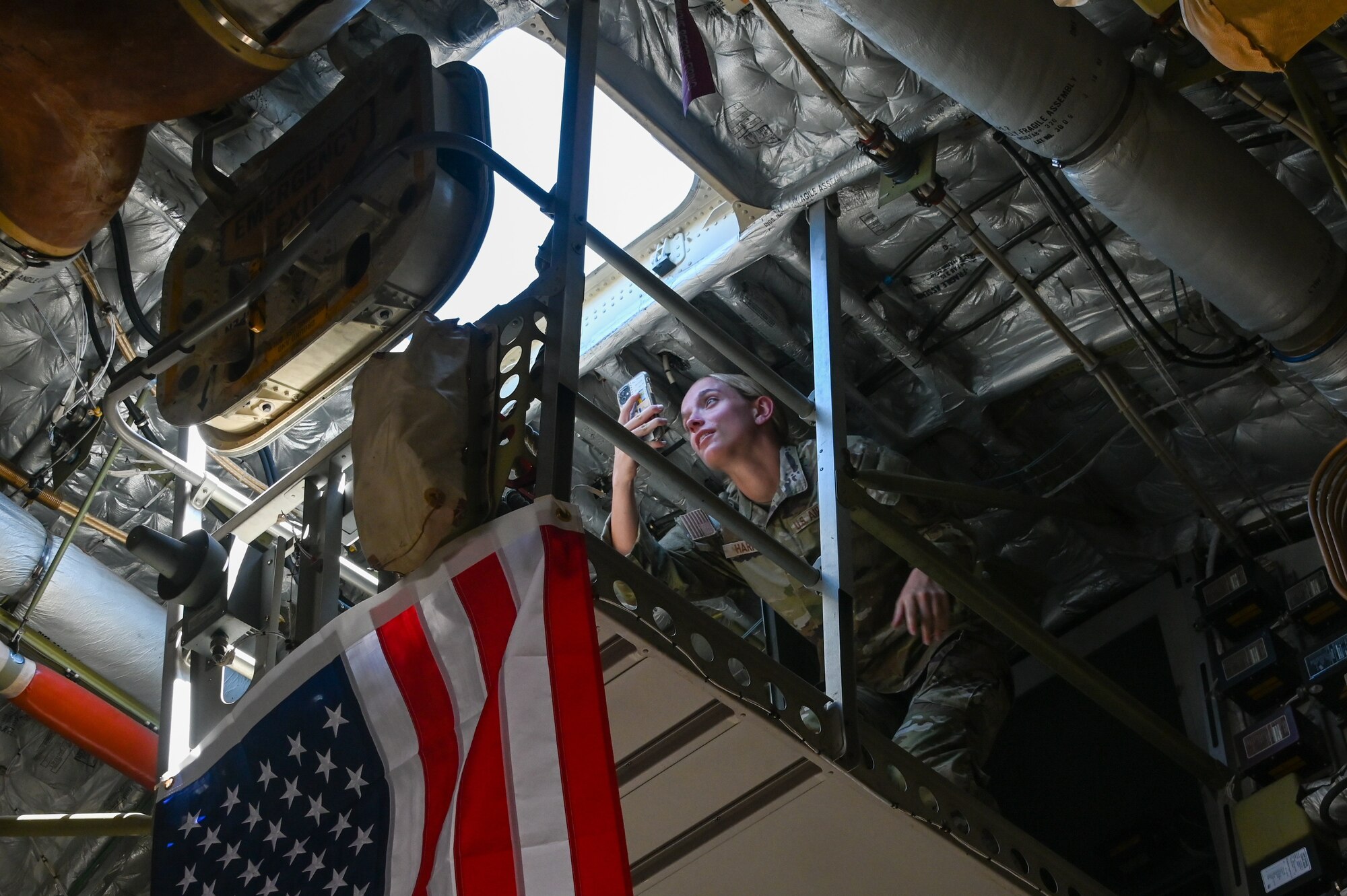 Caroline Harris, Embry-Riddle Detachment 157 Air Force ROTC cadet, videos her ascent onto the catwalk of a C-17 Globemaster III aircraft at Altus Air Force Base, Oklahoma, June 24, 2024. Many of the cadets expressed interest in becoming mobility Airmen in the future. (U.S. Air Force photo by Airman 1st Class Kari Degraffenreed)