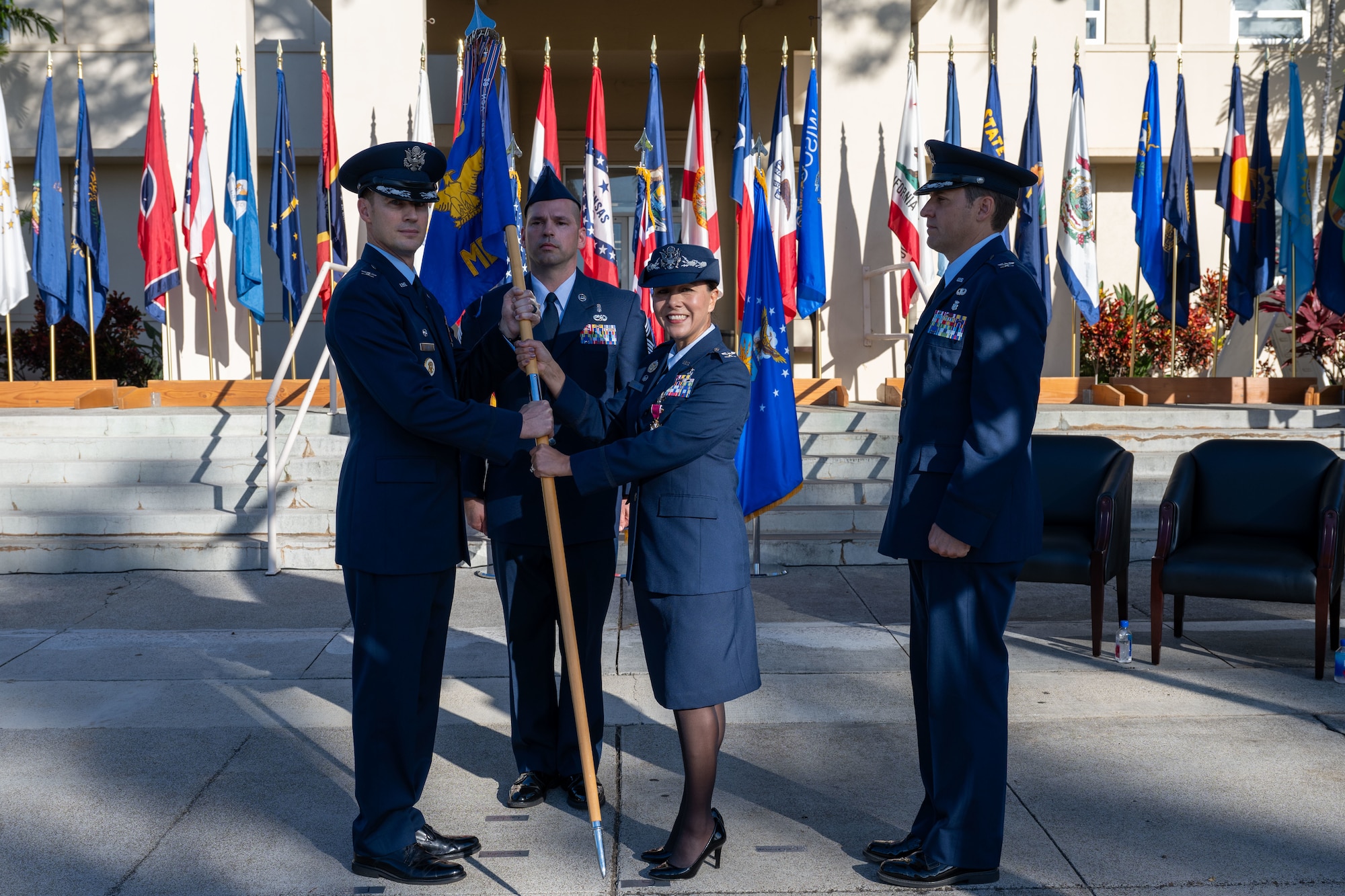Airmen hold a guidon.