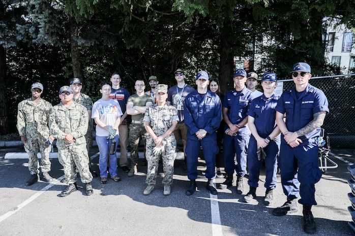 U.S. Navy Sailors, Marines, and Coast Guardsman pose for a group photo with employees during a community event at Seattle Children's Hospital in Seattle as part of Seattle Seafair Fleet Week Aug. 1, 2024.  Seattle Fleet Week is a time-honored celebration of the sea services and provides an opportunity for the citizens of Washington to meet Sailors, Marines and Coast Guardsmen, as well as witness firsthand the latest capabilities of today’s maritime services. (U.S. Navy photo by Mass Communication Specialist 1st Class Jacob I. Allison)