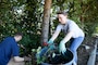 U.S. Coast Guard Marine Science Technician 2nd Class Angelina Gerber, assigned to USCG Sector Puget Sound, dumps ivy into a bin during a community event at Seattle Children's Hospital in Seattle as part of Seattle Seafair Fleet Week Aug. 1, 2024.  Seattle Fleet Week is a time-honored celebration of the sea services and provides an opportunity for the citizens of Washington to meet Sailors, Marines and Coast Guardsmen, as well as witness firsthand the latest capabilities of today’s maritime services. (U.S. Navy photo by Mass Communication Specialist 1st Class Jacob I. Allison)