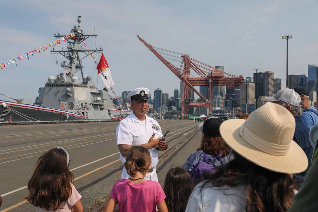 U.S. Navy Senior Chief Information System Technician Kala Lopes, a Sailor aboard the guided missile destroyer USS Sampson (DDG 102) leads a tour for visitors aboard USS Sampson during Seattle Seafair Fleet Week Aug. 2, 2024.  Seattle Fleet Week is a time-honored celebration of the sea services and provides an opportunity for the citizens of Washington to meet Sailors, Marines and Coast Guardsmen, as well as witness firsthand the latest capabilities of today’s maritime services. (U.S. Navy photo by Mass Communication Specialist 1st Class Jacob I. Allison)