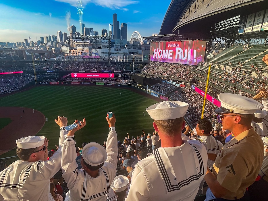 U.S. Navy Sailors and Marines celebrate a Seattle Mariners home run during a baseball game at T-Mobile Stadium in Seattle during Seattle Seafair Fleet Week Aug. 2, 2024.  Seattle Fleet Week is a time-honored celebration of the sea services and provides an opportunity for the citizens of Washington to meet Sailors, Marines and Coast Guardsmen, as well as witness firsthand the latest capabilities of today’s maritime services. (U.S. Navy photo by Mass Communication Specialist 1st Class Jacob I. Allison)